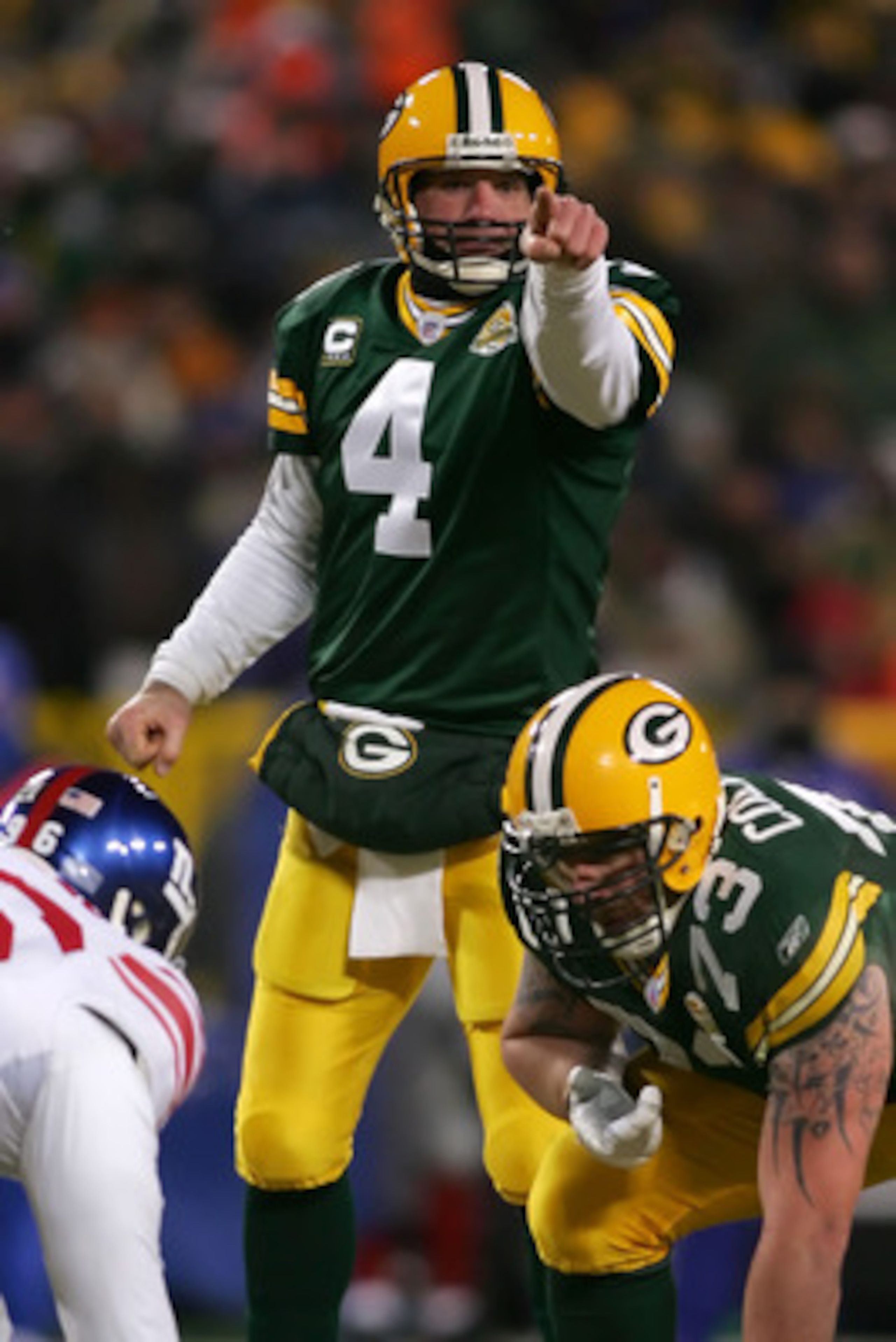 GREEN BAY, WI - JANUARY 20:  Quarterback Brett Favre #4 of the Green Bay Packers points during the third quarter of the NFC championship game against the New York Giants on January 20, 2008 at Lambeau Field in Green Bay, Wisconsin.  (Photo by Jonathan Fer