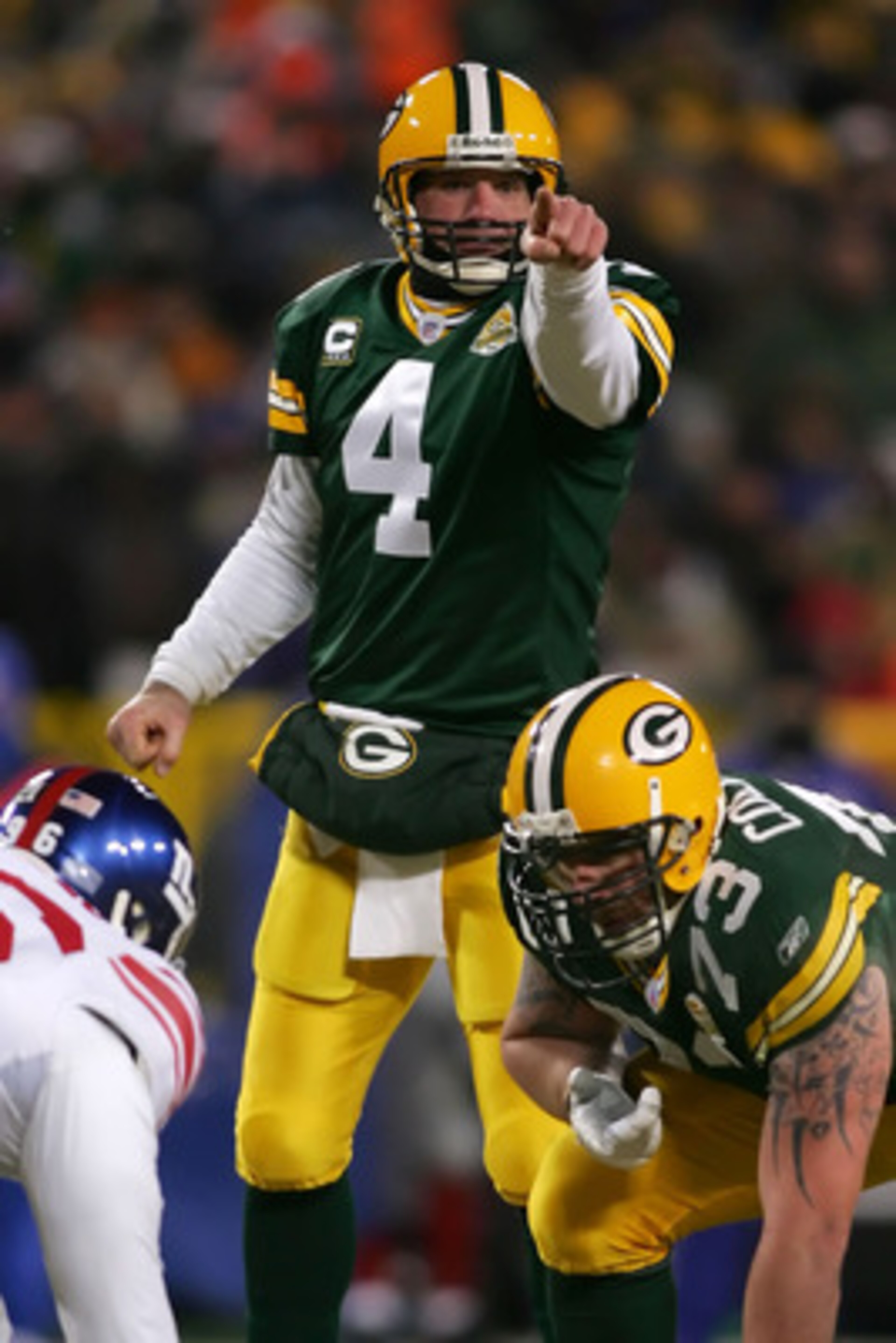 GREEN BAY, WI - JANUARY 20:  Quarterback Brett Favre #4 of the Green Bay Packers points during the third quarter of the NFC championship game against the New York Giants on January 20, 2008 at Lambeau Field in Green Bay, Wisconsin.  (Photo by Jonathan Fer
