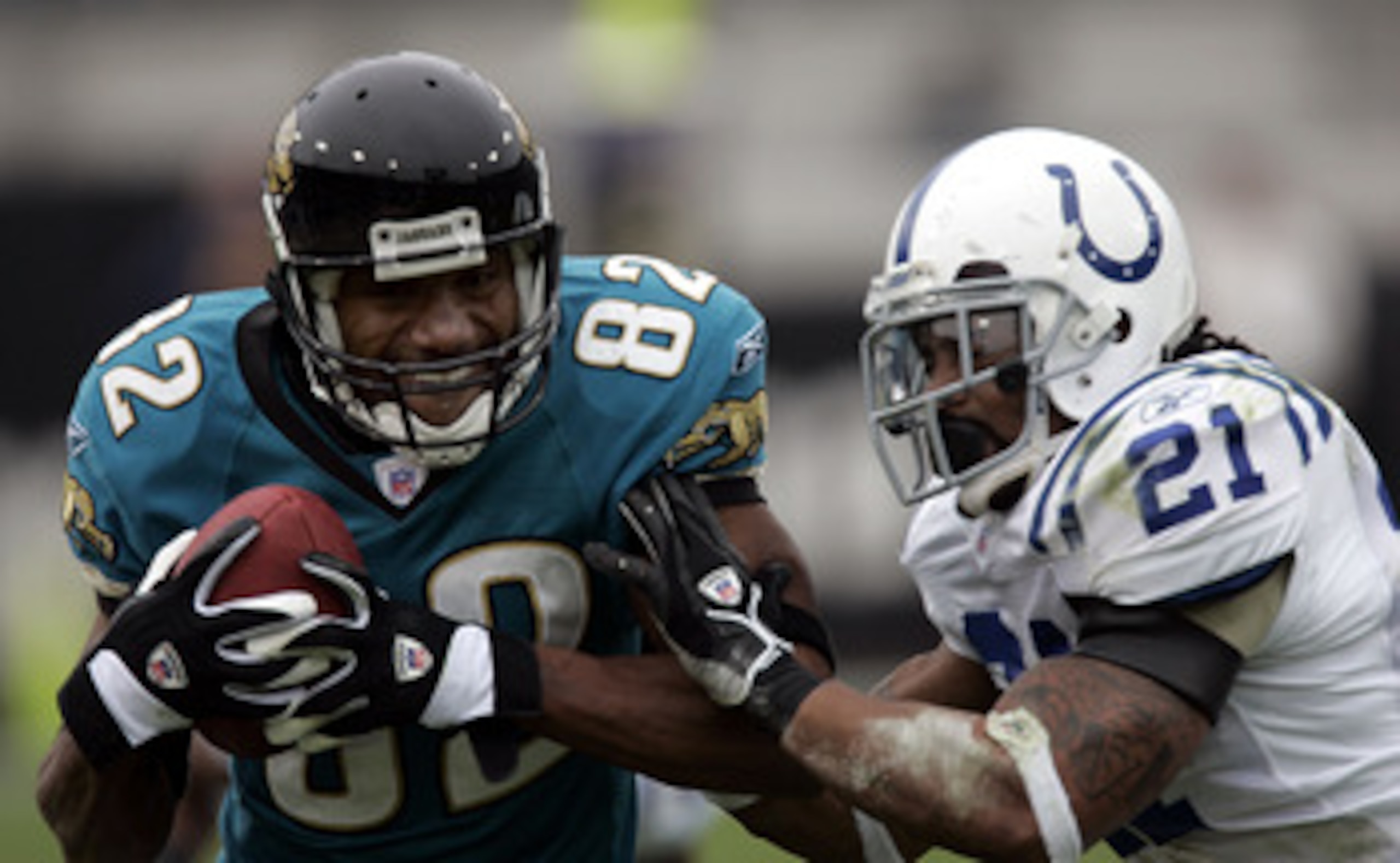 JACKSONVILLE - DECEMBER 11: Wide receiver Jimmy Smith #82 of the Jacksonville Jaguars is stopped by Defensive back Bob Sanders #21 of the Indianapolis Colts on December 11, 2005 at Alltel Stadium in Jacksonville, Florida. (Photo by Eliot J. Schechter/Gett