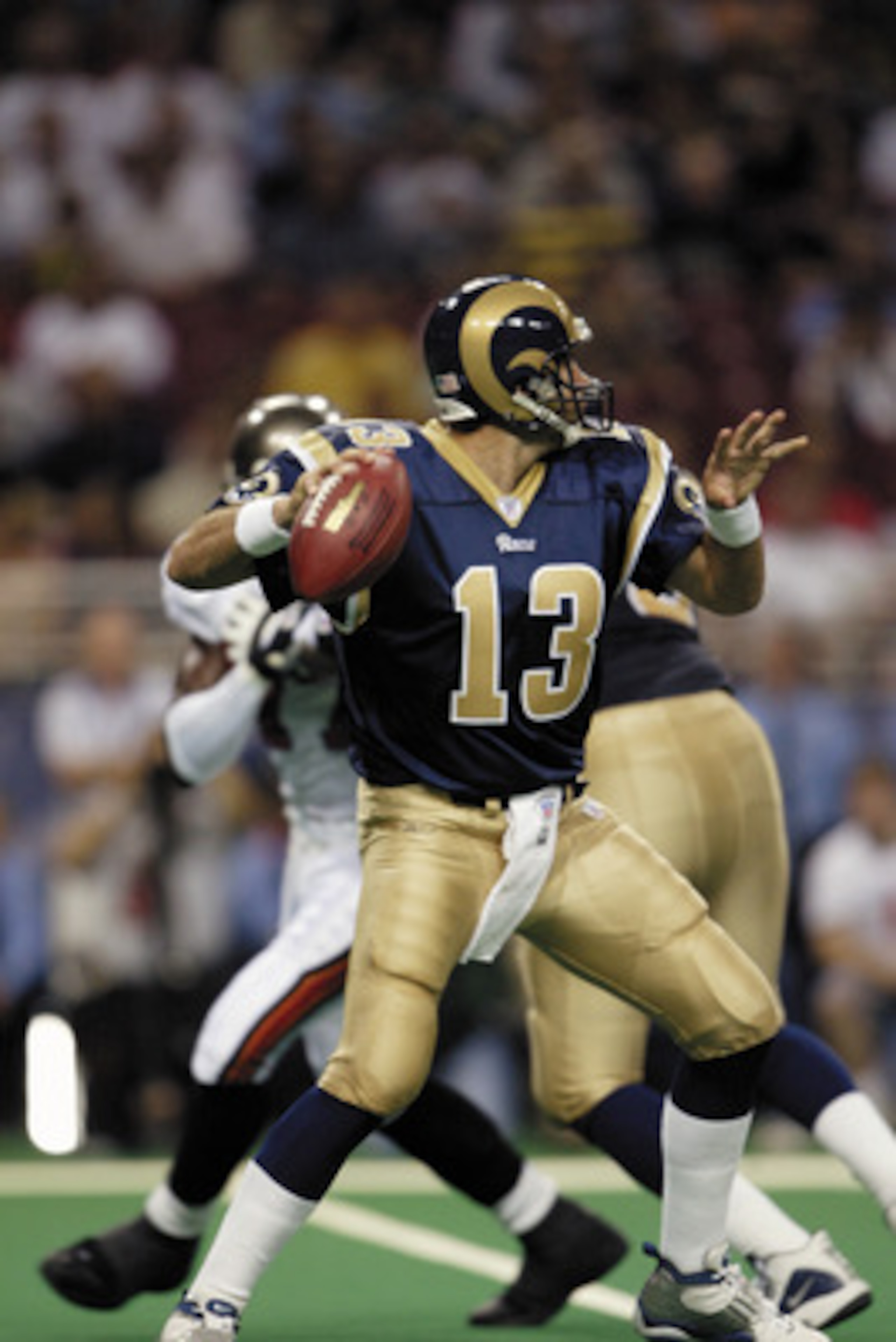 ST. LOUIS, MO - AUGUST 18:  Quarterback Kurt Warner #13 of the St. Louis Rams looks to pass against the Tampa Bay Buccaneers during the NFL preseason game at the Edward Jones Dome on August 18, 2003 in St. Louis, Missouri.  The Rams defeated the Buccaneer