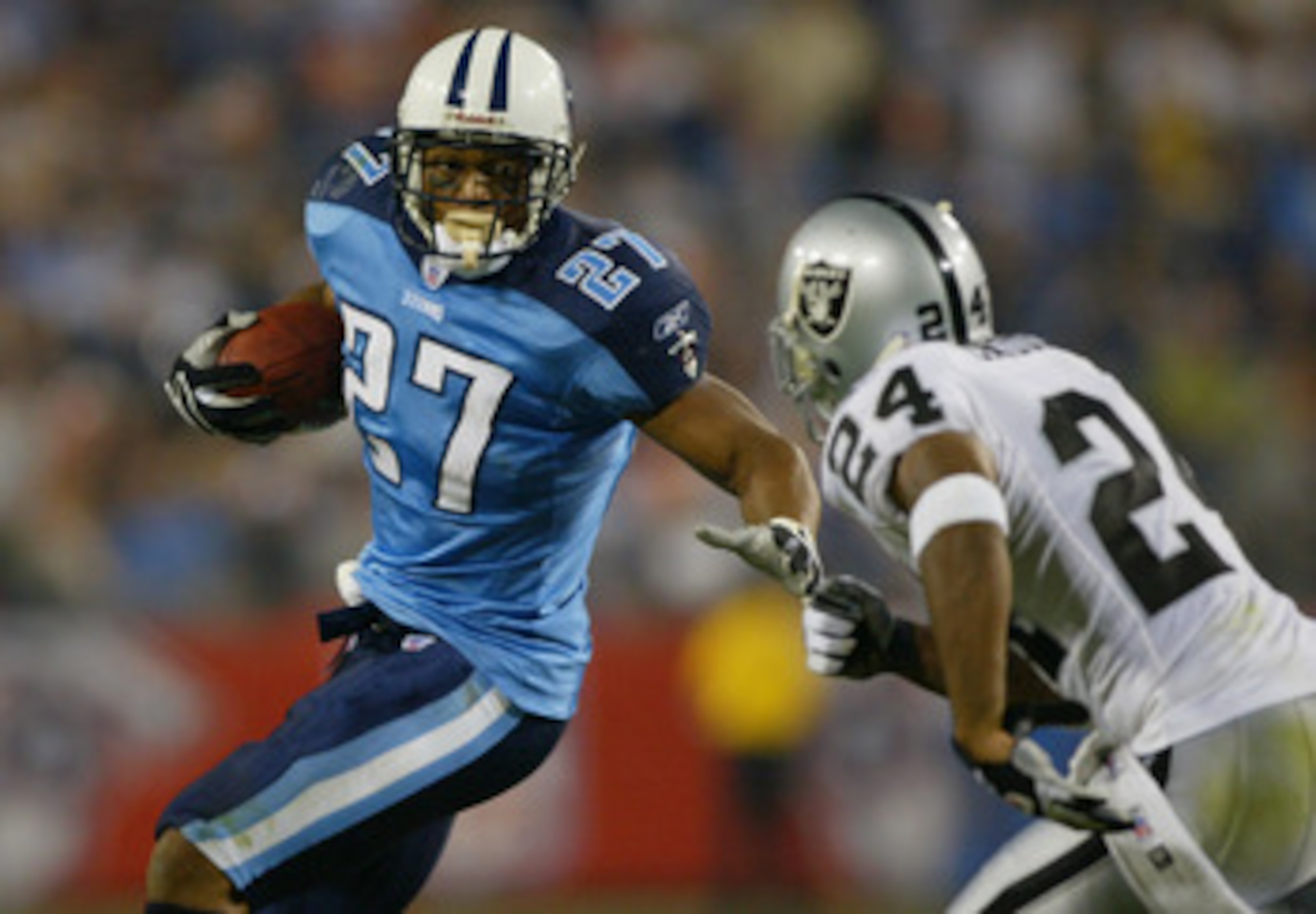 NASHVILLE, TN - SEPTEMBER 7:  Charles Woodson #24 of the Oakland Raiders goes after Eddie George #27 of the Tennessee Titans on September 7, 2003 at the The Coliseum in Nashville, Tennessee. The Titans defeated the Raiders 25-20. (Photo by Jamie Squire/Ge