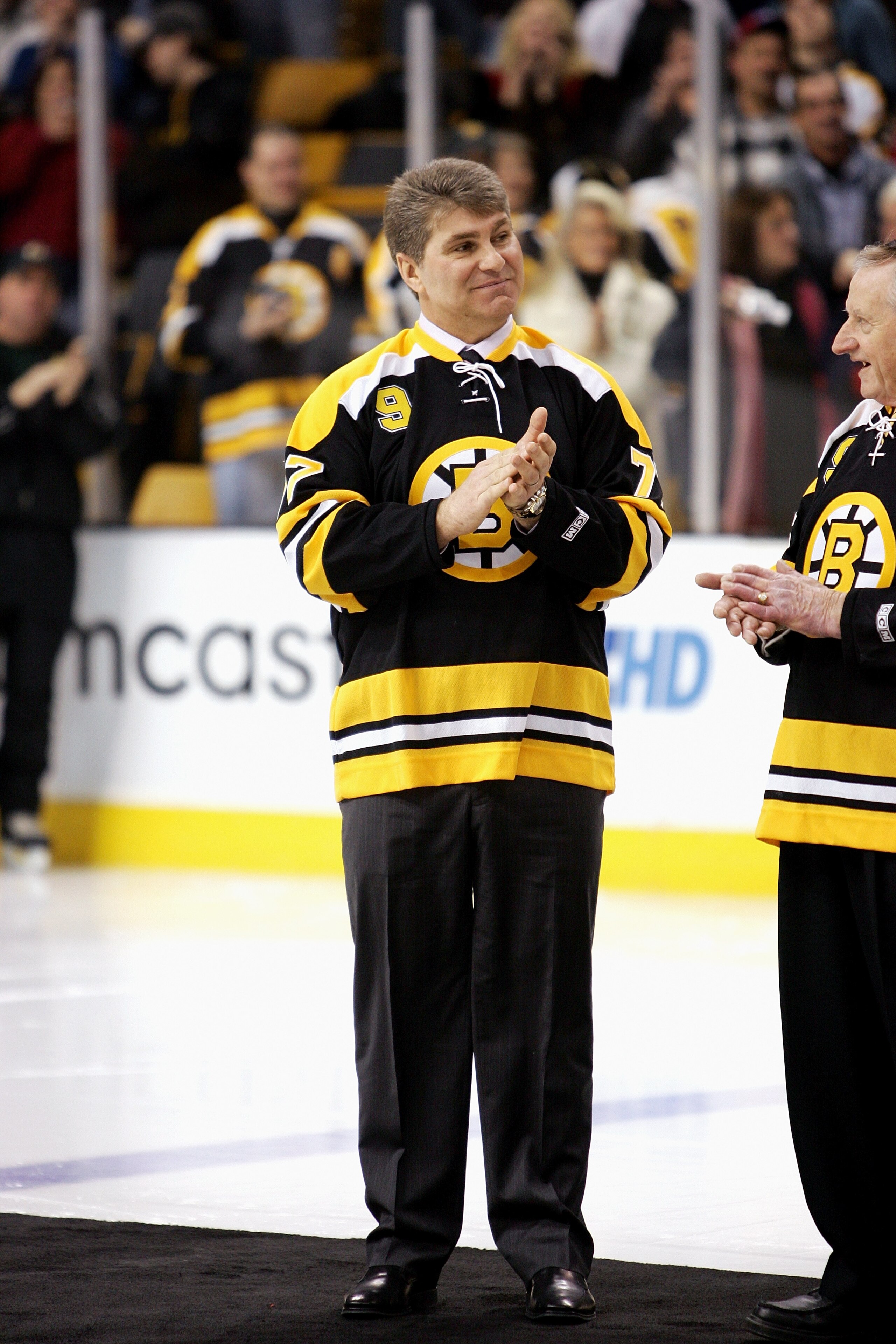 BOSTON - FEBRUARY 13: Former Boston Bruins player Ray Bourque claps his hands during the ceremony honoring John Bucyk for his 50 years with the Bruins organization before the game against the Edmonton Oilers on February 13, 2007 at TD Banknorth Garden in BOSTON - FEBRUARY 13: Former Boston Bruins player Ray Bourque claps his hands during the ceremony honoring John Bucyk for his 50 years with the Bruins organization before the game against the Edmonton Oilers on February 13, 2007 at TD Banknorth Garden in