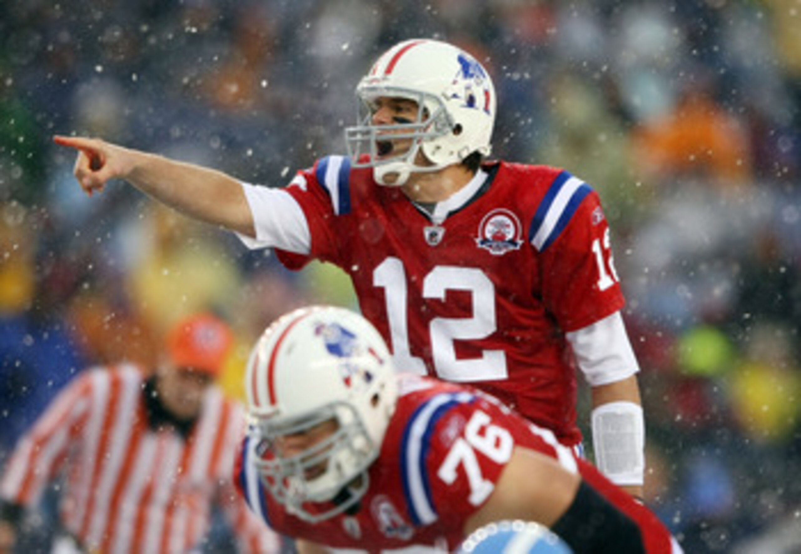 FOXBORO, MA - OCTOBER 18:  Quarterback Tom Brady #12 of the New England Patriots calls out the play as Sebastian Vollmer #76 listens in the first quarter against the Tennessee Titans on October 18, 2009 at Gillette Stadium in Foxboro, Massachusetts.  (Pho
