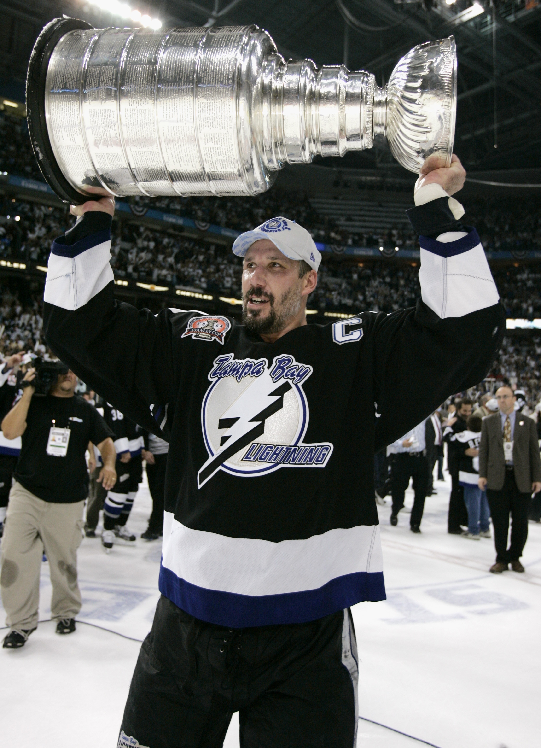 TAMPA, FL - JUNE 7:  Dave Andreychuk #25 of the Tampa Bay Lightning holds the Stanley Cup above his head after the victory over the Calgary Flames in Game seven of the NHL Stanley Cup Finals on June 7, 2004 at the St. Pete Times Forum in Tampa, Florida.