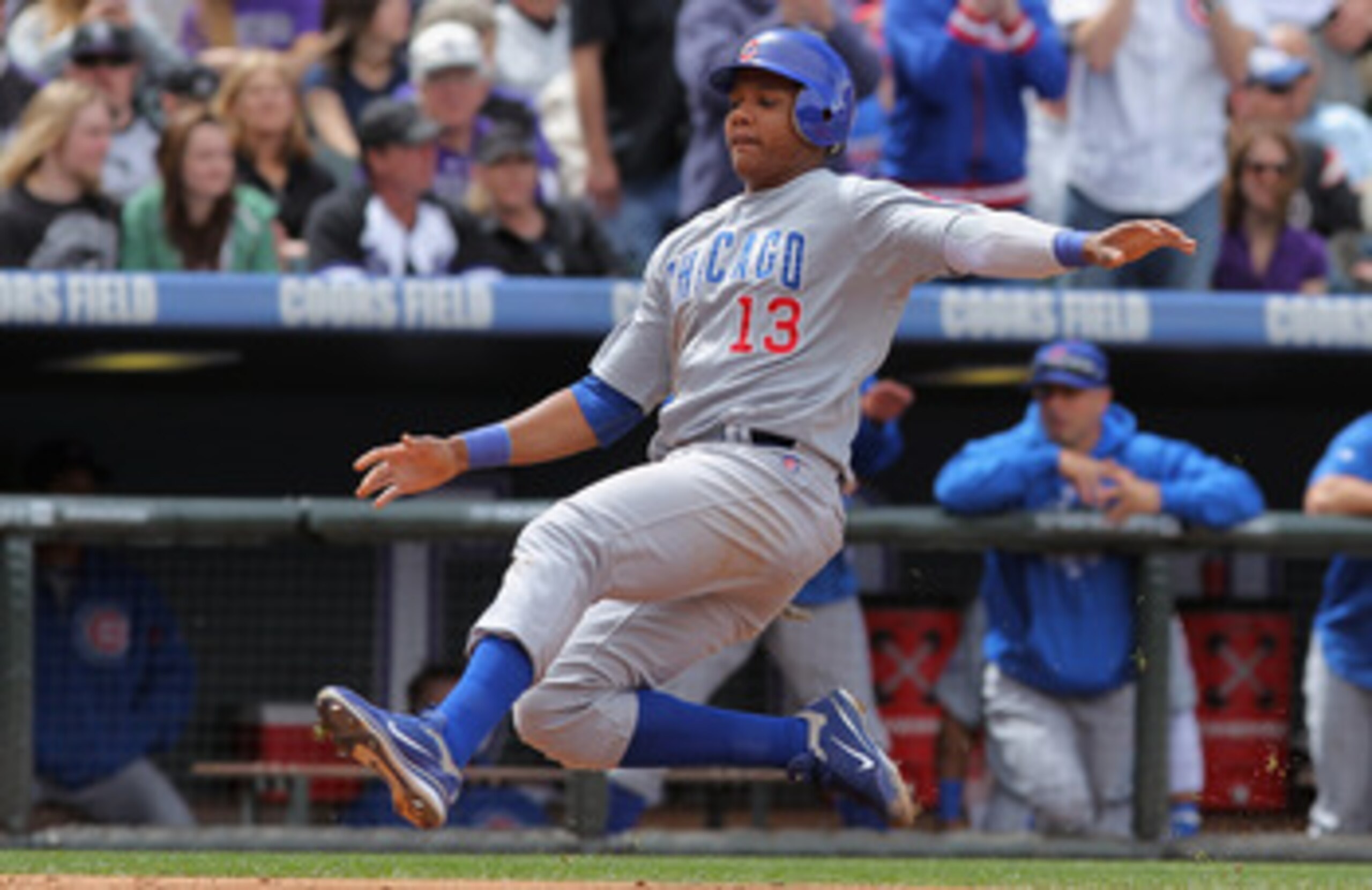 DENVER, CO - APRIL 17:  Starlin Castro #13 of the Chicago Cubs slides home to score against the Colorado Rockies at Coors Field on April 17, 2011 in Denver, Colorado.  (Photo by Doug Pensinger/Getty Images)