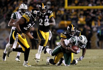 PITTSBURGH, PA - JANUARY 23:  Santonio Holmes #10 of the New York Jets is tackled by Ike Taylor #24 of the Pittsburgh Steelers during the 2011 AFC Championship game at Heinz Field on January 23, 2011 in Pittsburgh, Pennsylvania. The Steelers won 24-19. (P