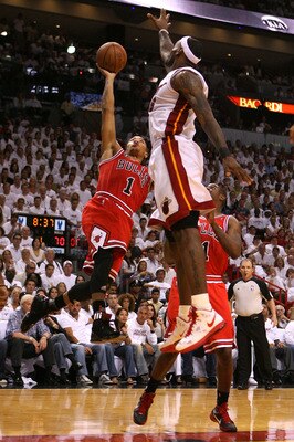 MIAMI, FL - MAY 22:  Derrick Rose #1 of the Chicago Bulls drives for a shot attempt against LeBron James #6 of the Miami Heat in Game Three of the Eastern Conference Finals during the 2011 NBA Playoffs on May 22, 2011 at American Airlines Arena in Miami,