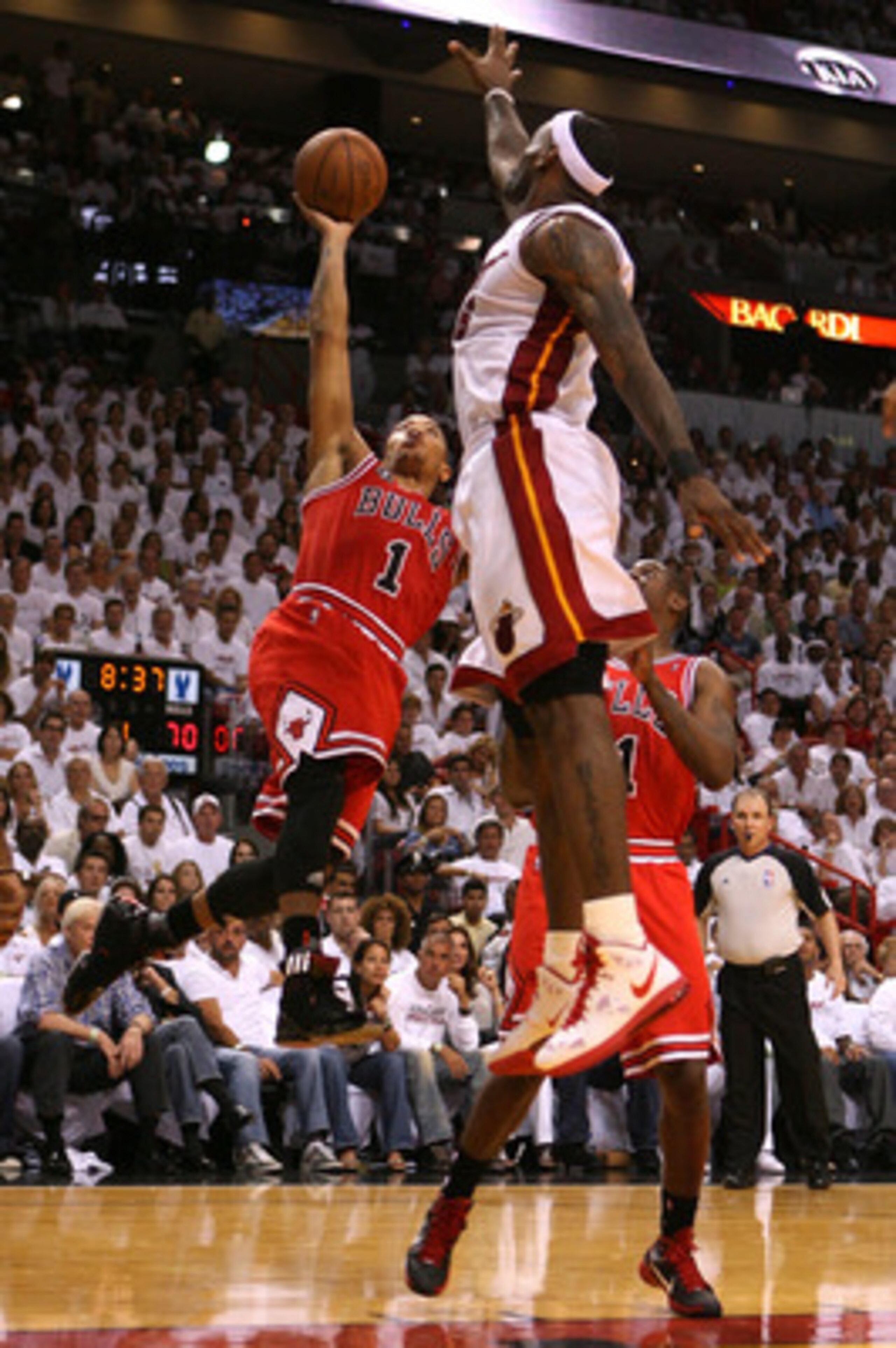 MIAMI, FL - MAY 22:  Derrick Rose #1 of the Chicago Bulls drives for a shot attempt against LeBron James #6 of the Miami Heat in Game Three of the Eastern Conference Finals during the 2011 NBA Playoffs on May 22, 2011 at American Airlines Arena in Miami,
