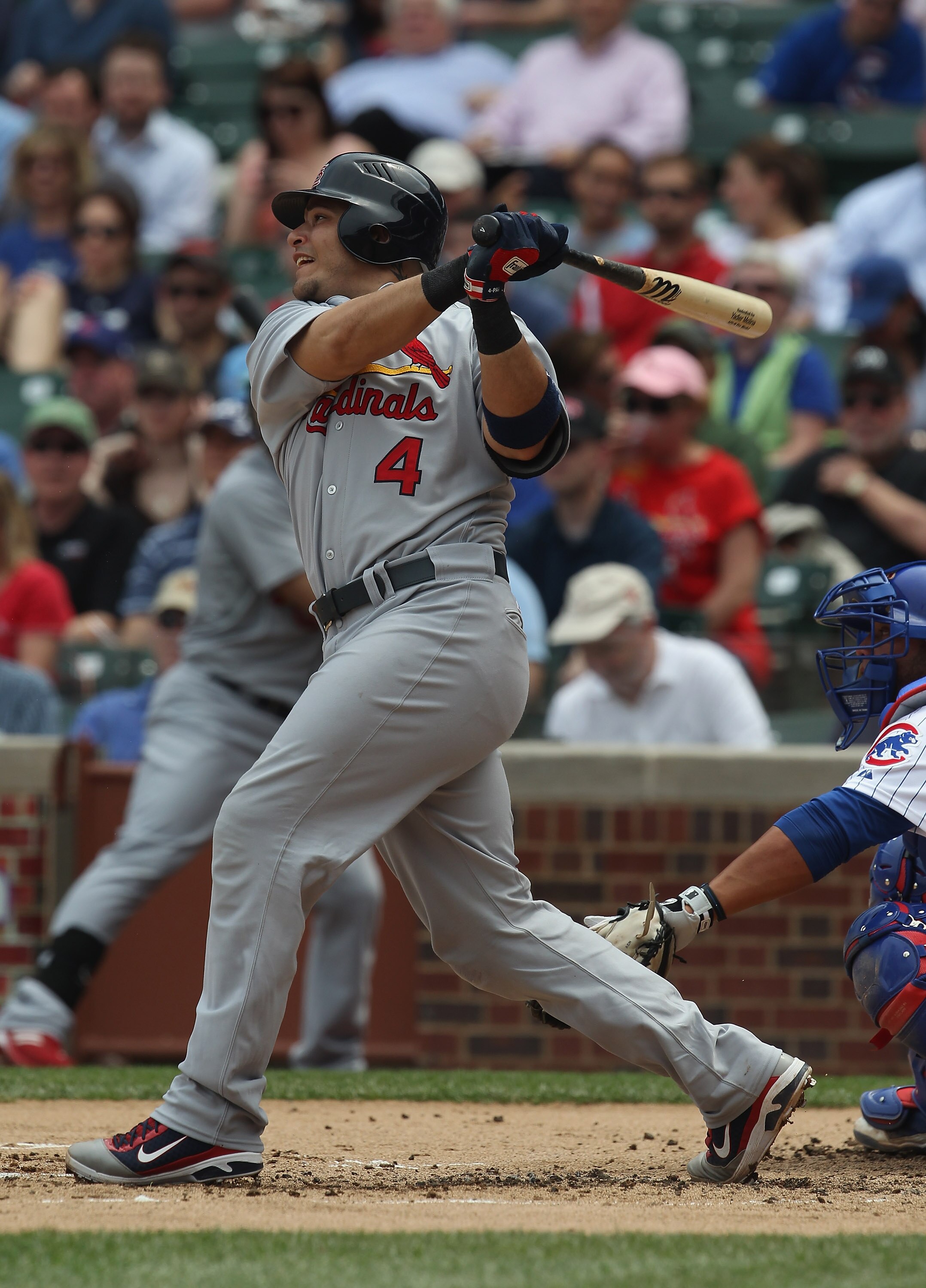 CHICAGO, IL - MAY 12: Yadier Molina #4 of the St. Louis Cardinals hits a run-scoring double in the 2nd inning against the Chicago Cubs at Wrigley Field on May 12, 2011 in Chicago, Illinois. The Cardinals defeated the Cubs 9-1. (Photo by Jonathan Daniel/Ge