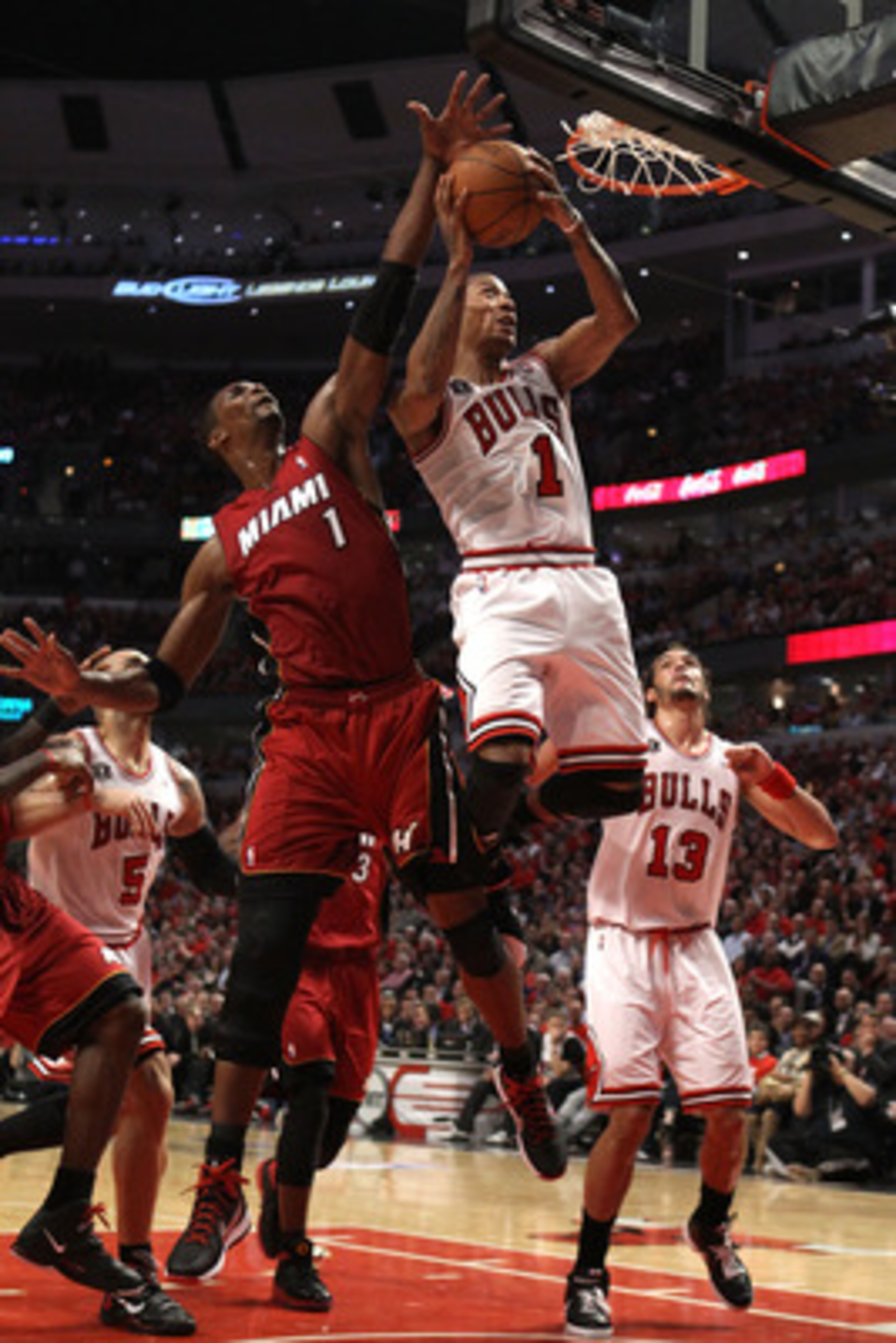 CHICAGO, IL - MAY 18:  Derrick Rose #1 of the Chicago Bulls drives for a shot attempt against Chris Bosh #1 of the Miami Heat in Game Two of the Eastern Conference Finals during the 2011 NBA Playoffs on May 18, 2011 at the United Center in Chicago, Illino