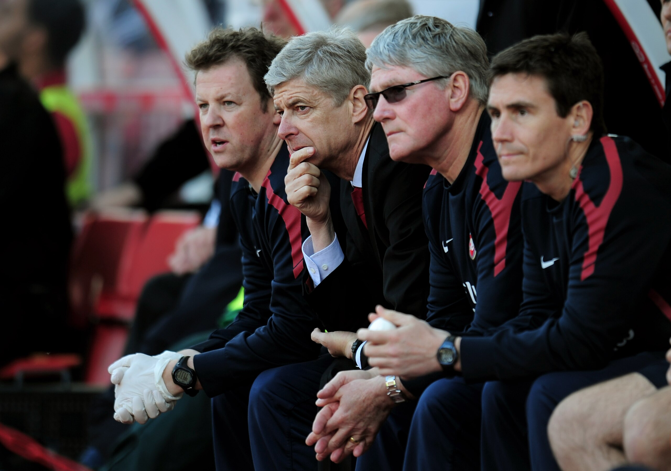 STOKE ON TRENT, ENGLAND - MAY 08:  A dejected Arsene Wenger (2nd L) the Arsenal manager looks on as his team head towards a 3-1 defeat during the Barclays Premier League match between Stoke City and Arsenal at the Britannia Stadium on May 8, 2011 in Stoke
