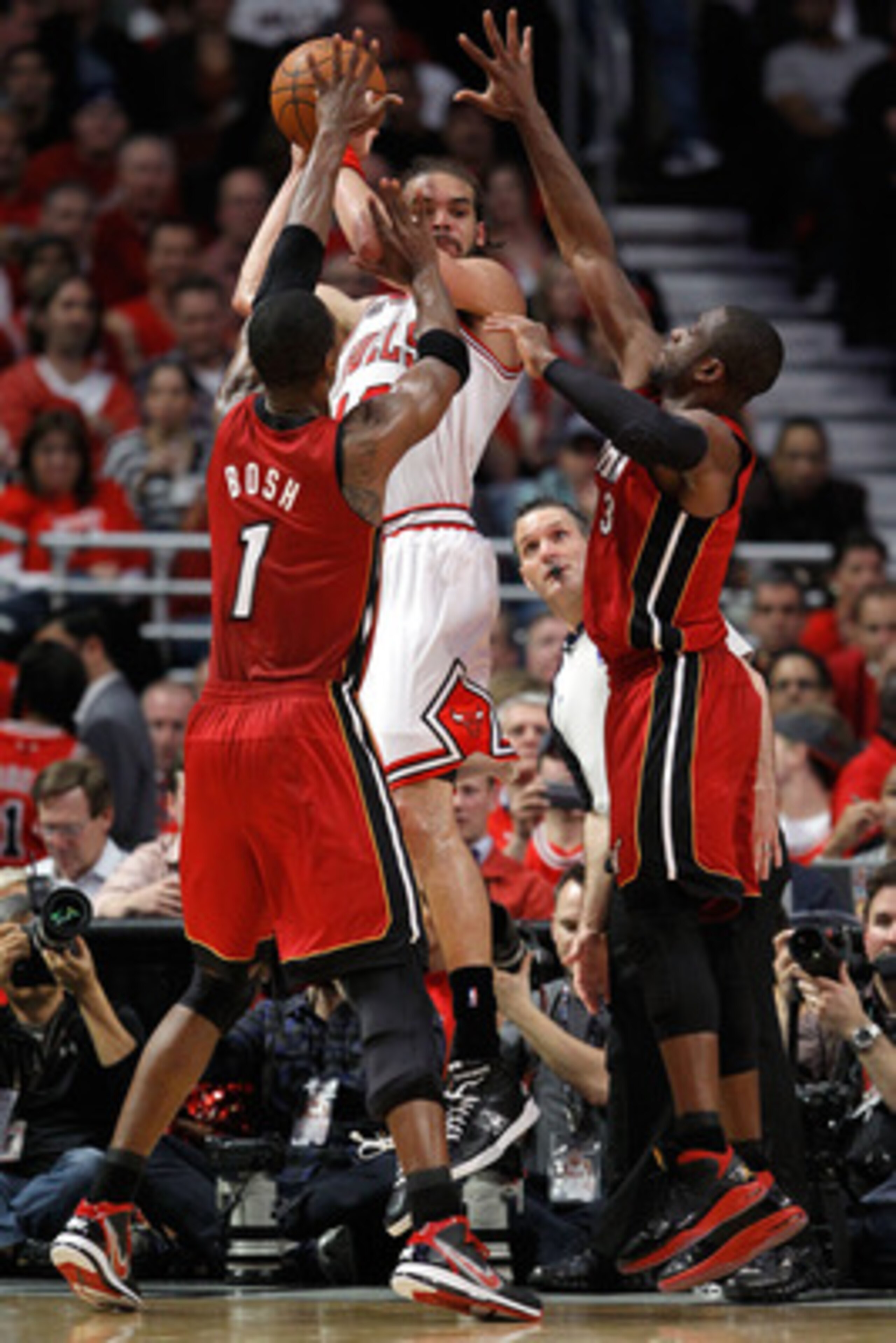 CHICAGO, IL - MAY 18: Joakim Noah #13 of the Chicago Bulls looks to pass as he is defended by Chris Bosh #1 and Dwyane Wade #3 of the Miami Heat in Game Two of the Eastern Conference Finals during the 2011 NBA Playoffs on May 18, 2011 at the United Cente CHICAGO, IL - MAY 18: Joakim Noah #13 of the Chicago Bulls looks to pass as he is defended by Chris Bosh #1 and Dwyane Wade #3 of the Miami Heat in Game Two of the Eastern Conference Finals during the 2011 NBA Playoffs on May 18, 2011 at the United Cente