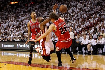 MIAMI, FL - MAY 22:  Dwyane Wade #3 of the Miami Heat loses the ball as he drives against Kyle Korver #26 and Derrick Rose #1 of the Chicago Bulls in Game Three of the Eastern Conference Finals during the 2011 NBA Playoffs on May 22, 2011 at American Airl