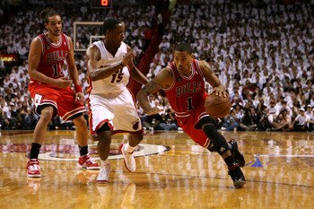 MIAMI, FL - MAY 22:  Derrick Rose #1 of the Chicago Bulls drives against Mario Chalmers #15 of the Miami Heat in Game Three of the Eastern Conference Finals during the 2011 NBA Playoffs on May 22, 2011 at American Airlines Arena in Miami, Florida.  NOTE T