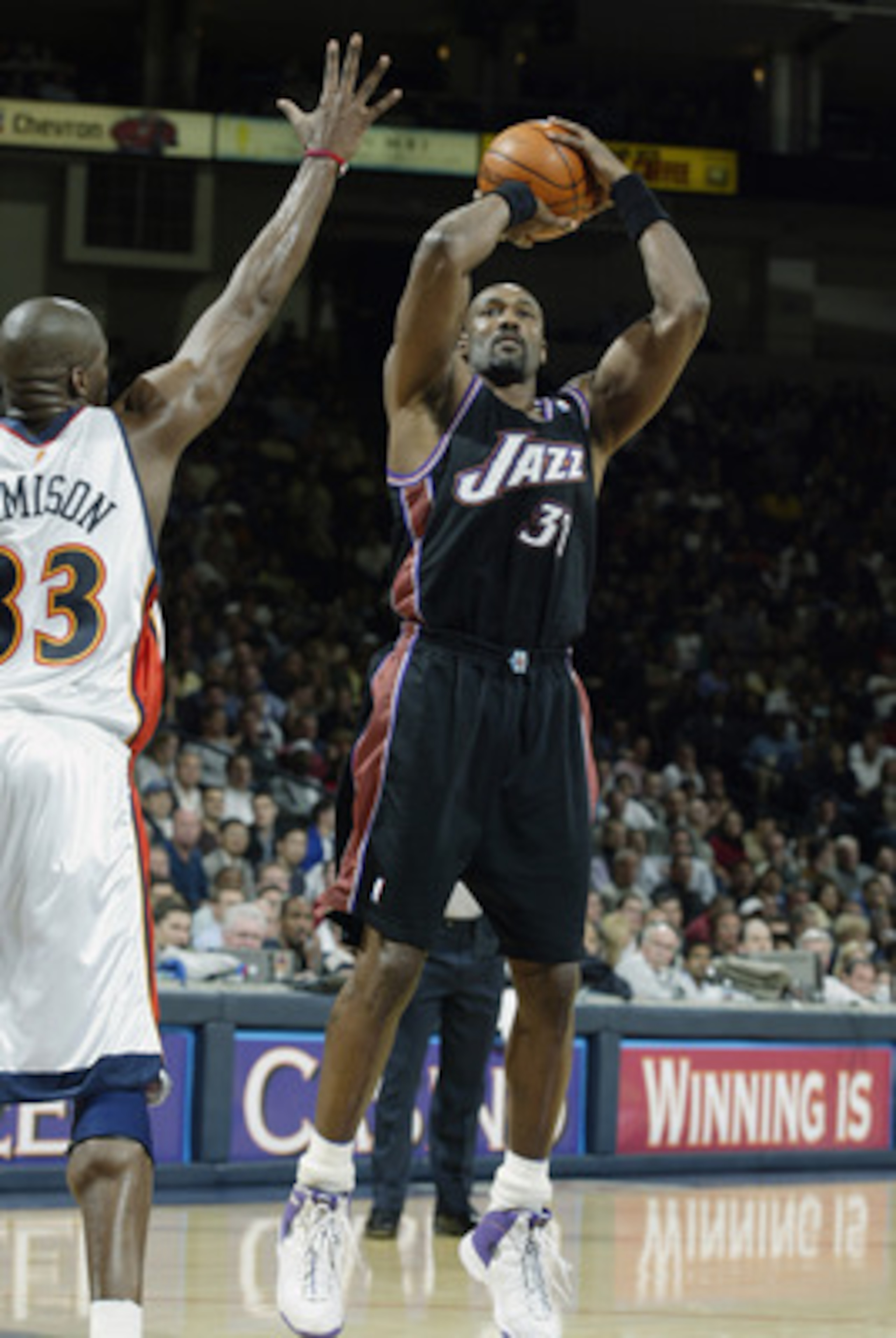 OAKLAND, CA - APRIL 8:  Karl Malone #32 of the Utah Jazz shoots over Antawn Jamison #33 of the Golden State Warriors during the game at The Arena in Oakland on April 8, 2003 in Oakland, California.  The Warriors won 128-102.  NOTE TO USER: User expressly