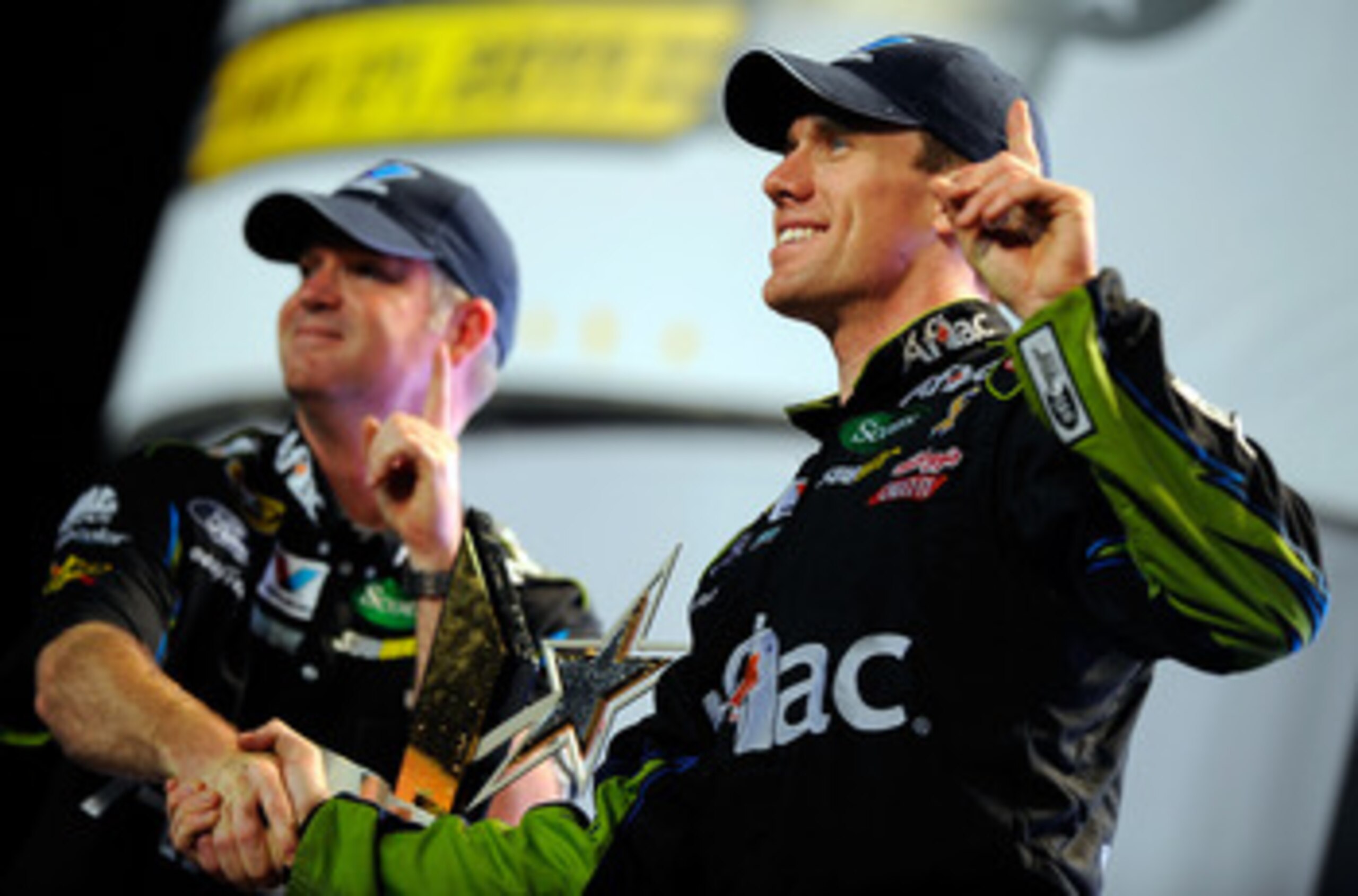 CHARLOTTE, NC - MAY 21:  Carl Edwards, driver of the #99 Aflac Ford, celebrates in victory lane with crew chief Bob Osborne after winning the NASCAR Sprint All-Star Race at Charlotte Motor Speedway on May 21, 2011 in Charlotte, North Carolina.  (Photo by