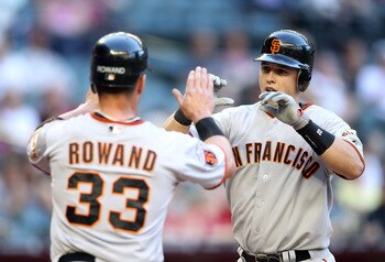 PHOENIX, AZ - APRIL 16:  Buster Posey #28 of the San Francisco Giants high fives teammate Aaron Rowand #33 after Posey hit a two run home run against the Arizona Diamondbacks during the first inning of the Major League Baseball game at Chase Field on Apri