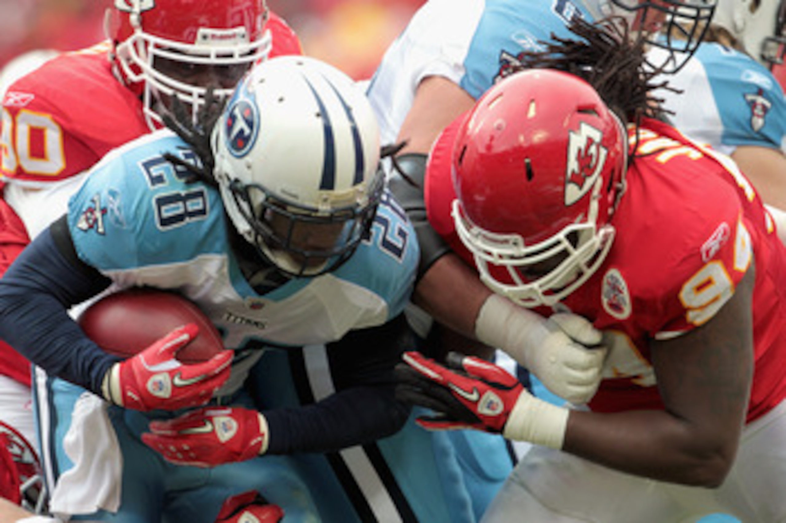 KANSAS CITY, MO - DECEMBER 26: Chris Johnson #28 of the Tennessee Titans carries the ball as Tyson Jackson #94 of the Kansas City Chiefs defends during the game on December 26, 2010 at Arrowhead Stadium in Kansas City, Missouri.  (Photo by Jamie Squire/Ge