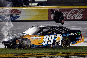 CHARLOTTE, NC - MAY 21:  Carl Edwards, driver of the #99 Aflac Ford, does a backflip in celebration after winning the NASCAR Sprint All-Star Race at Charlotte Motor Speedway on May 21, 2011 in Charlotte, North Carolina.  (Photo by Chris Graythen/Getty Ima