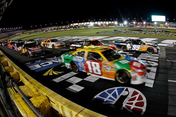CHARLOTTE, NC - MAY 21:  Carl Edwards, driver of the #99 Aflac Ford, and Kyle Busch, driver of the #18 M&M's Toyota, race against each other during the NASCAR Sprint All-Star Race at Charlotte Motor Speedway on May 21, 2011 in Charlotte, North Carolina.  
