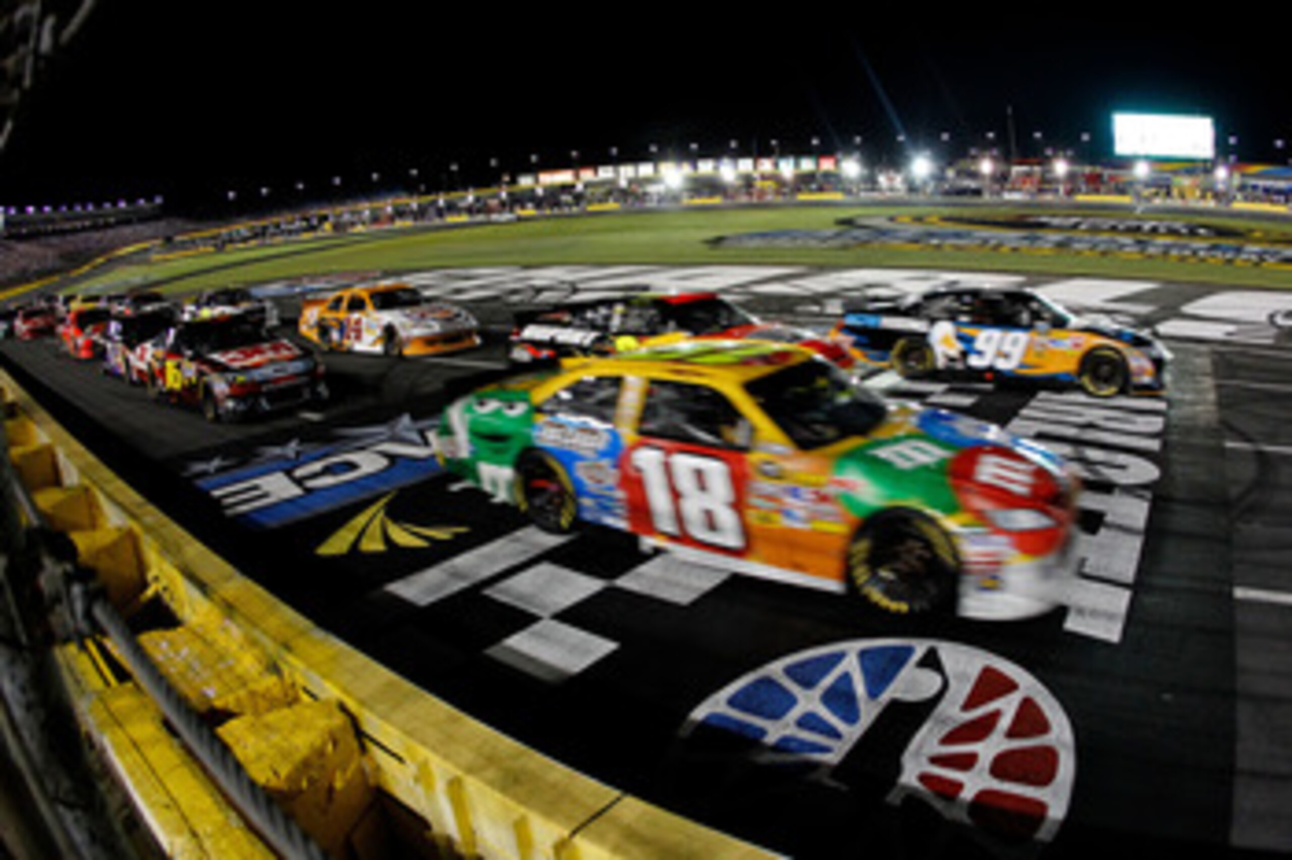 CHARLOTTE, NC - MAY 21:  Carl Edwards, driver of the #99 Aflac Ford, and Kyle Busch, driver of the #18 M&M's Toyota, race against each other during the NASCAR Sprint All-Star Race at Charlotte Motor Speedway on May 21, 2011 in Charlotte, North Carolina.  