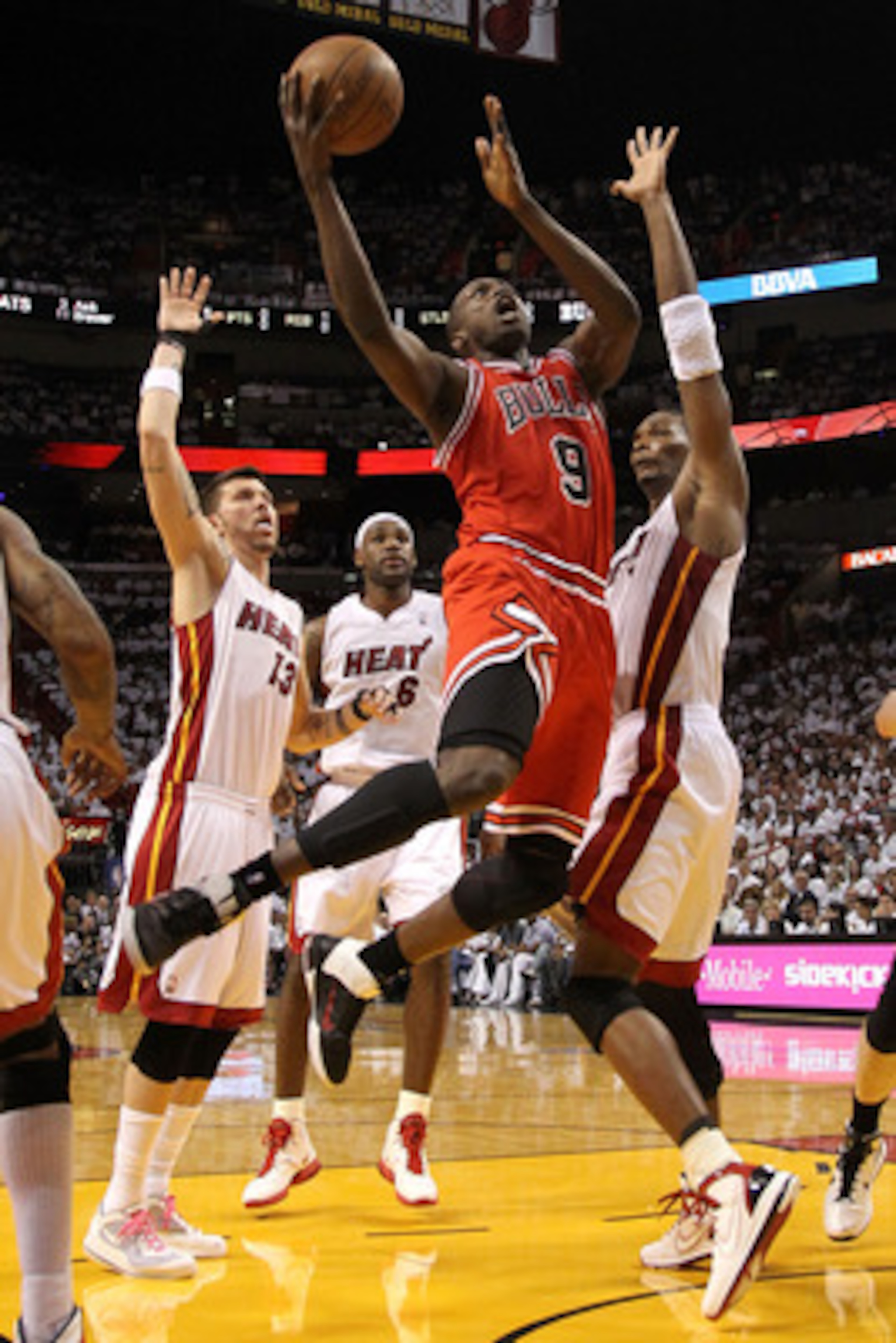 MIAMI, FL - MAY 22:  Luol Deng #9 of the Chicago Bulls drives for a shot attempt against Chris Bosh #1 of the Miami Heat in Game Three of the Eastern Conference Finals during the 2011 NBA Playoffs on May 22, 2011 at American Airlines Arena in Miami, Flori