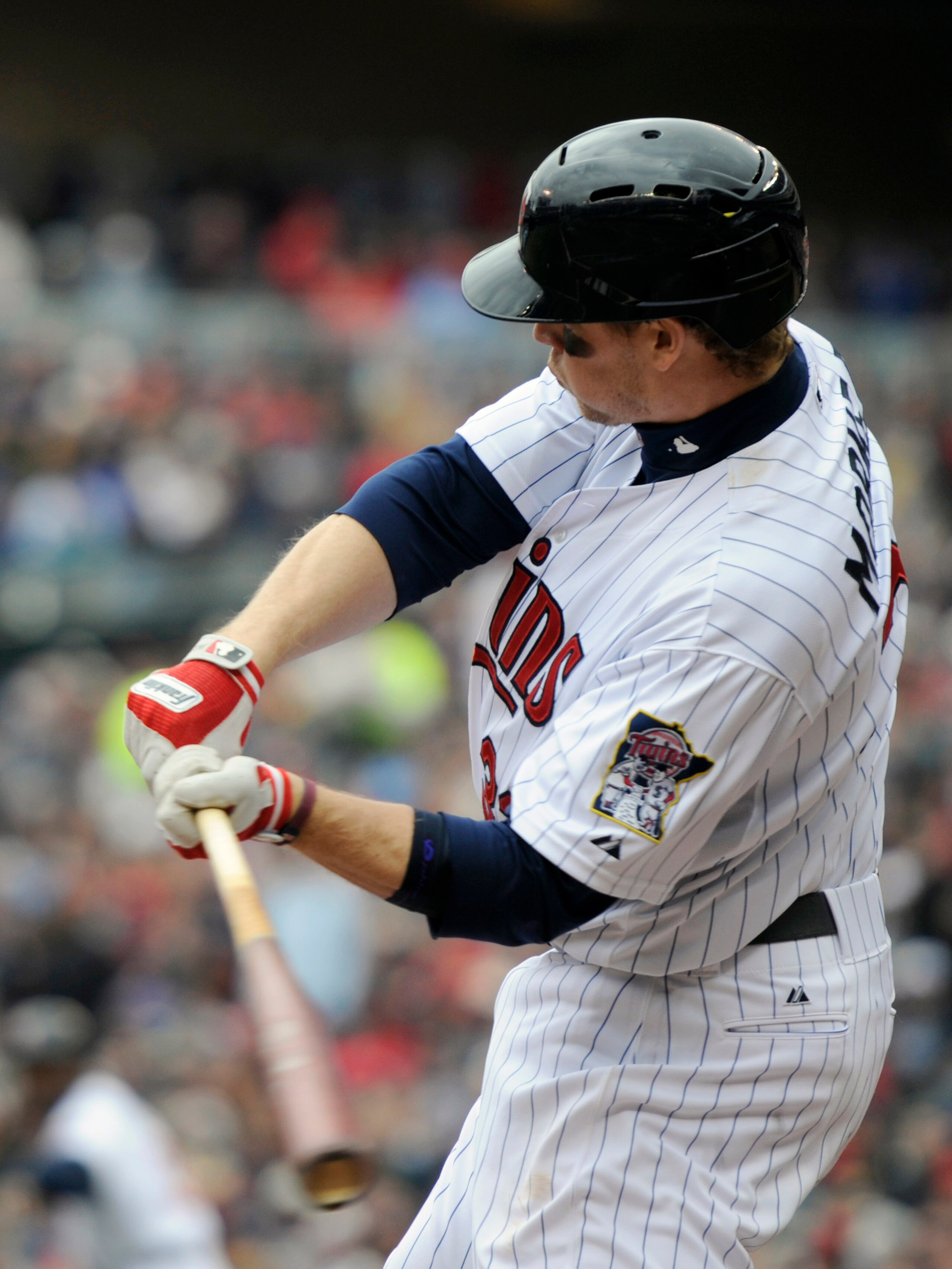 MINNEAPOLIS, MN - APRIL 23: Justin Morneau #33 of the Minnesota Twins hits an two-run single against the Cleveland Indians during the  inning of their game on April 23, 2011 at Target Field in Minneapolis, Minnesota. (Photo by Hannah Foslien/Getty Images)