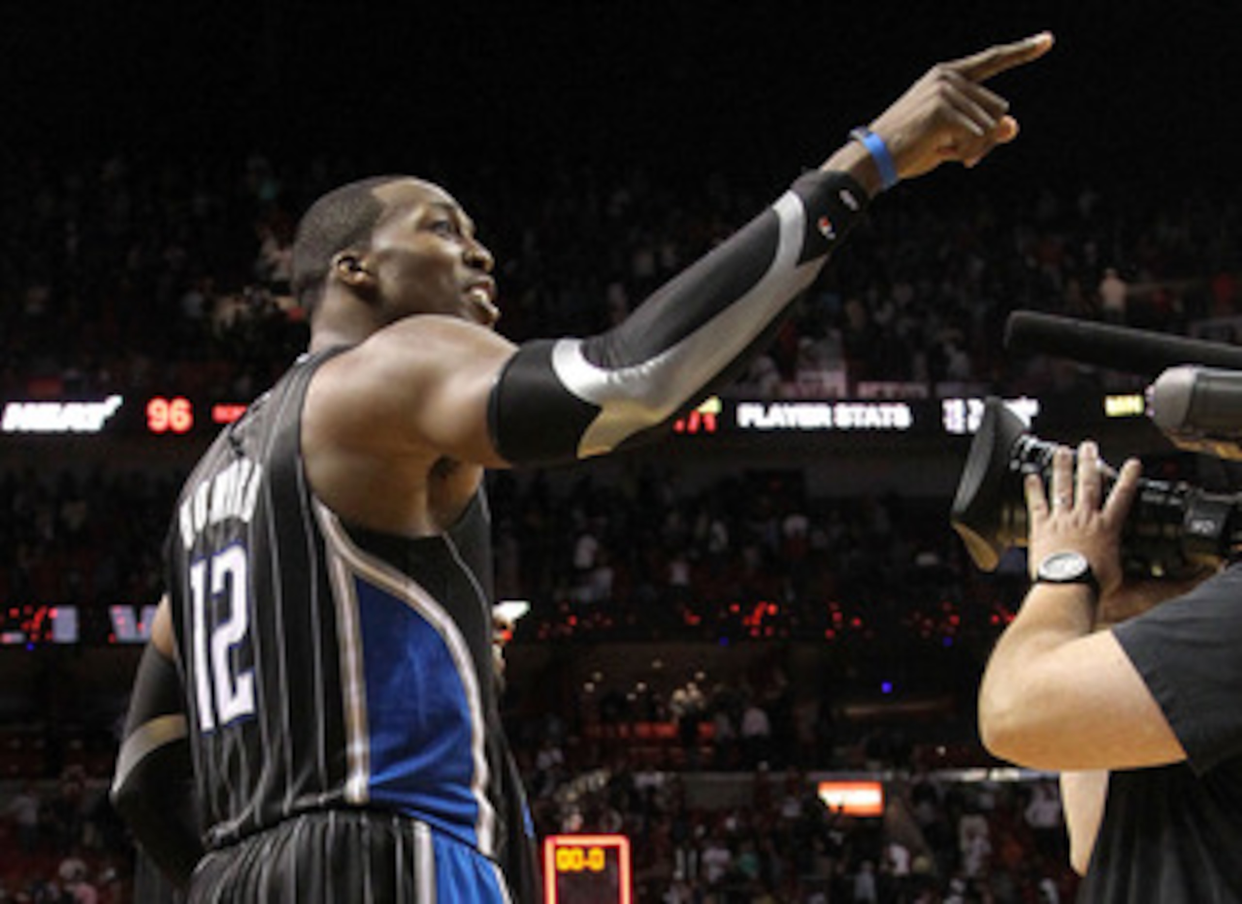 MIAMI, FL - MARCH 03: Dwight Howard #12 of the Orlando Magic points to a heckler after winning a game against the Miami Heat at American Airlines Arena on March 3, 2011 in Miami, Florida. NOTE TO USER: User expressly acknowledges and agrees that, by down MIAMI, FL - MARCH 03: Dwight Howard #12 of the Orlando Magic points to a heckler after winning a game against the Miami Heat at American Airlines Arena on March 3, 2011 in Miami, Florida. NOTE TO USER: User expressly acknowledges and agrees that, by down