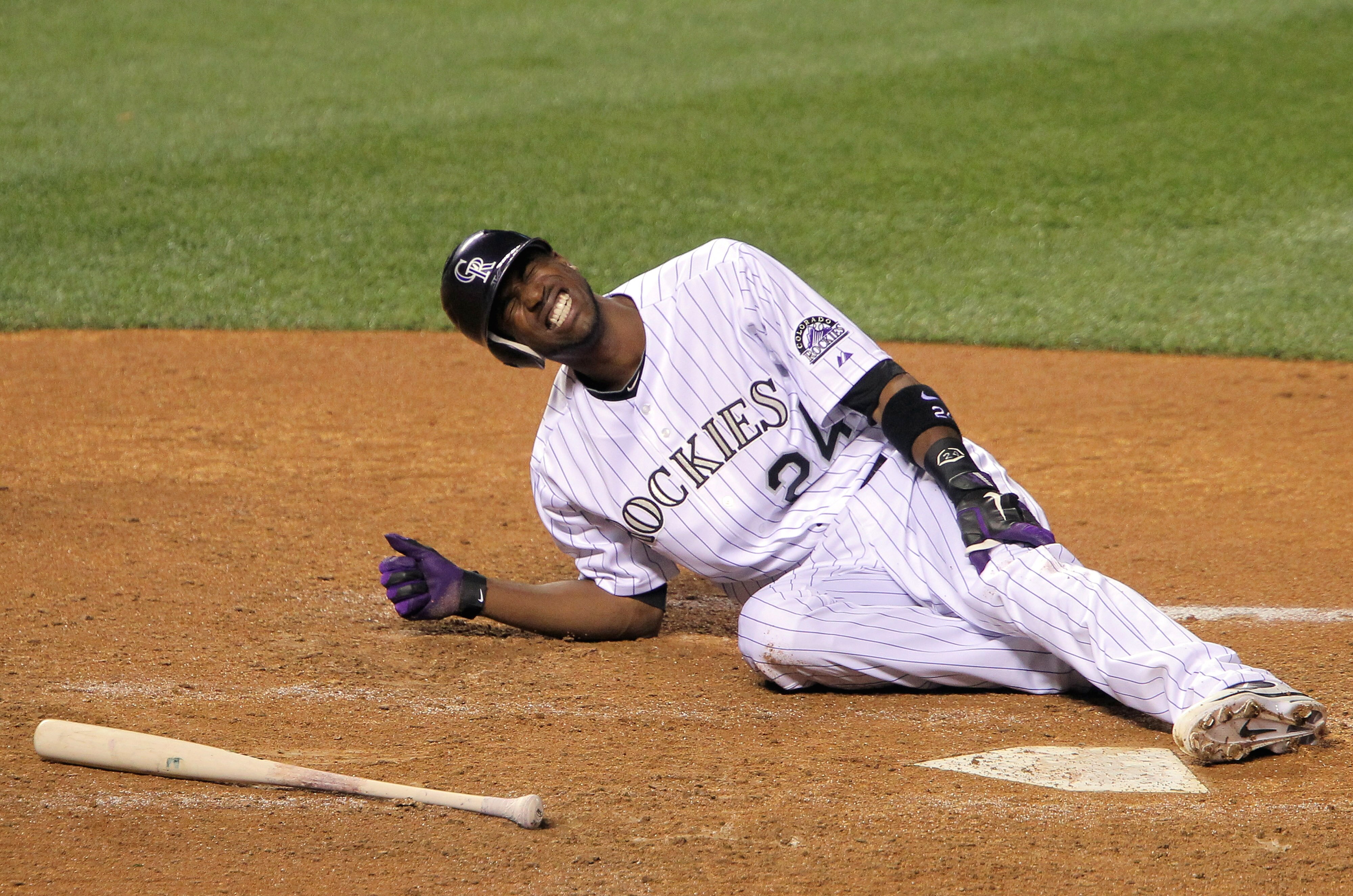 DENVER, CO - MAY 10:  Dexter Fowler #24 of the Colorado Rockies hits the ground after being injured during his at bat in the bottom of the seventh inning after the rain delay against the New York Mets at Coors Field on May 10, 2011 in Denver, Colorado. Fo