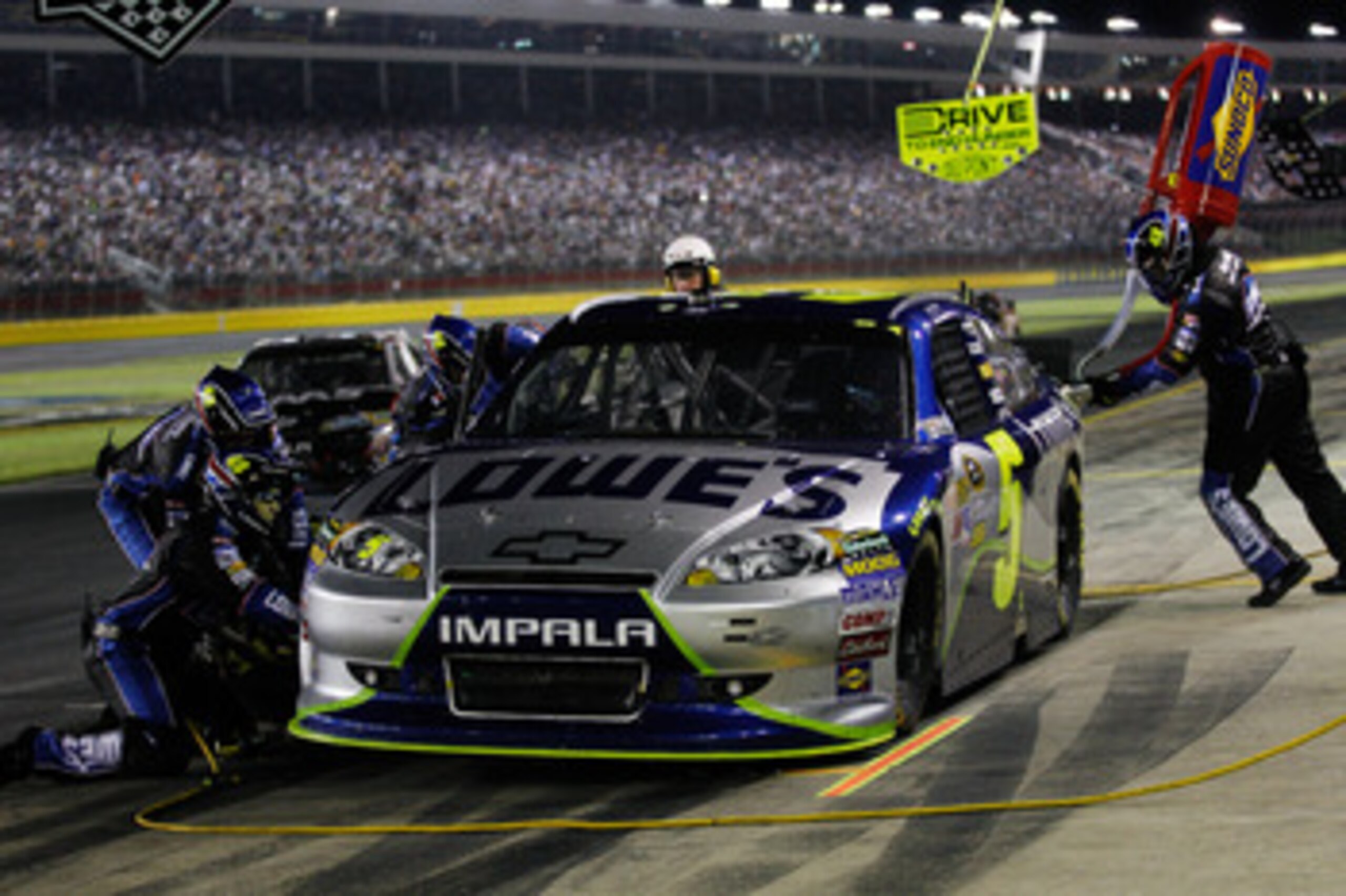 CHARLOTTE, NC - MAY 21:  Jimmie Johnson, driver of the #5 Lowe's 5% Every Day Chevrolet, makes a pit stop during the NASCAR Sprint All-Star Race at Charlotte Motor Speedway on May 21, 2011 in Charlotte, North Carolina.  (Photo by Chris Graythen/Getty Imag
