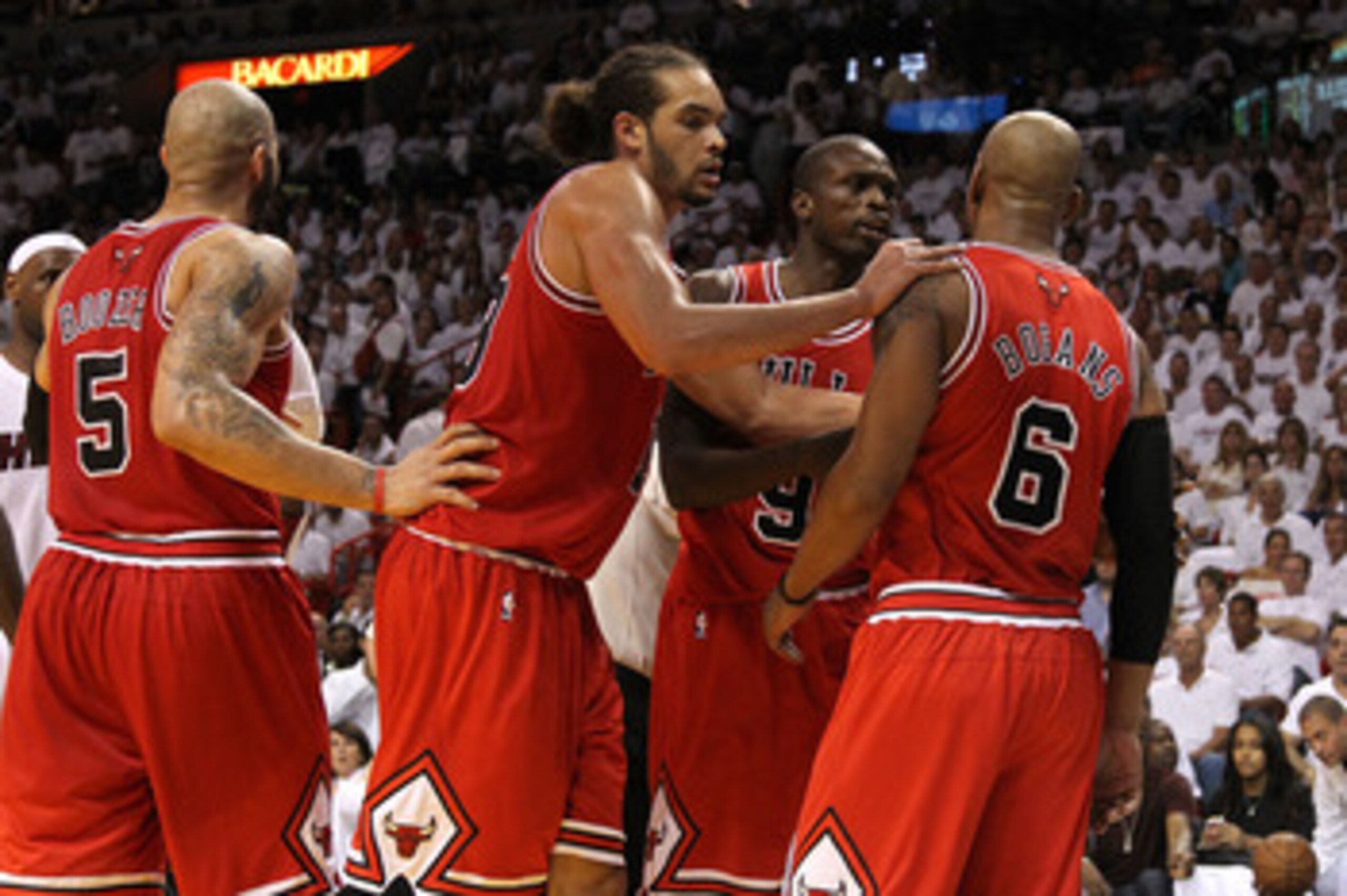 MIAMI, FL - MAY 22:  Joakim Noah #13 (2nd L) and Luol Deng #9 of the Chicago Bulls restrains Keith Bogans #6 in the second half against the Miami Heat in Game Three of the Eastern Conference Finals during the 2011 NBA Playoffs on May 22, 2011 at American