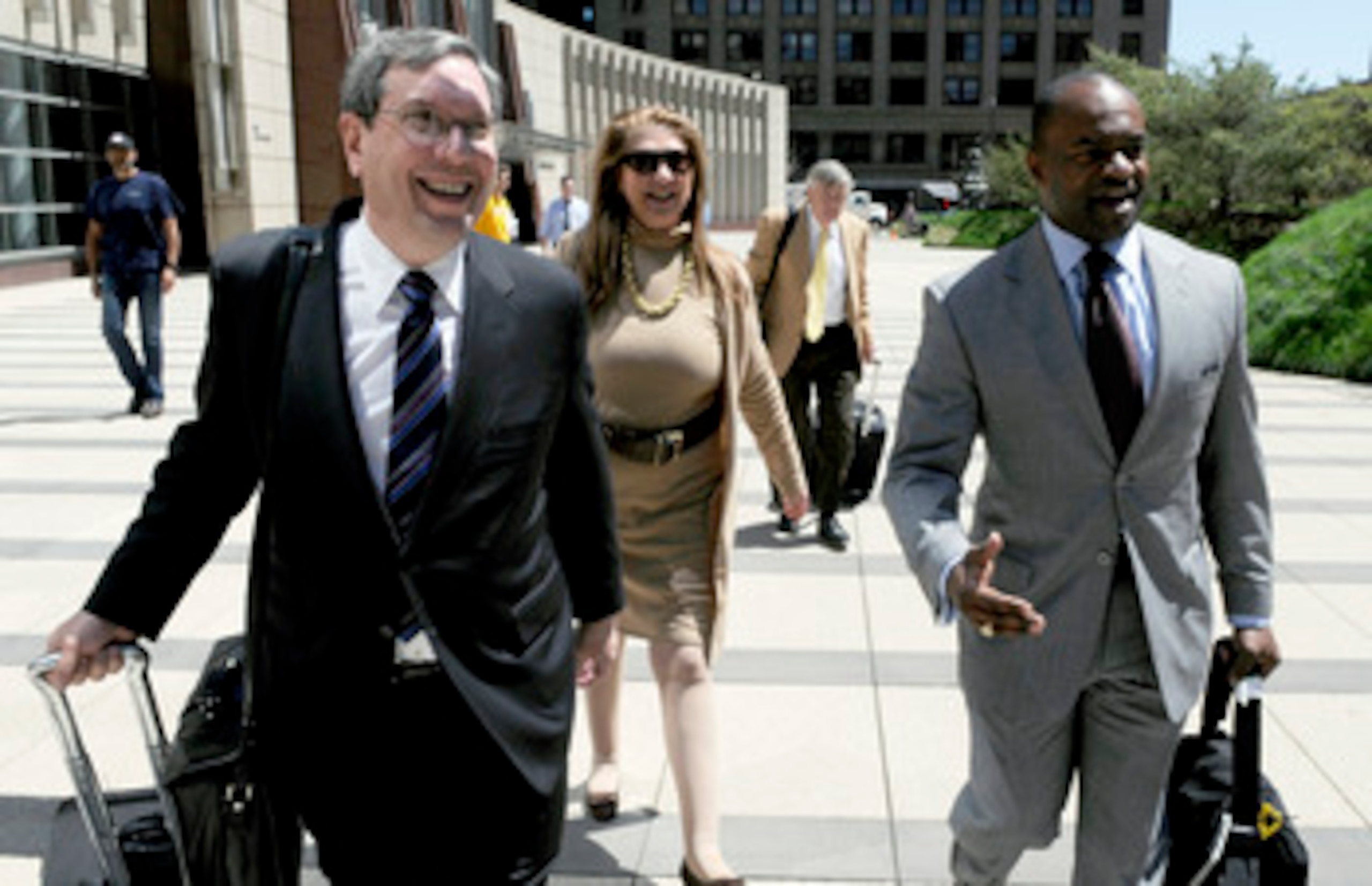MINNEAPOLIS, MN - MAY 17: NFL players' lawyers Jeffrey Kessler (L), Barbara P. Berens and James Quinn walk with former NFL Players Association executive director DeMaurice Smith after leaving court ordered mediation at the U.S. Courthouse on May 17, 2011 