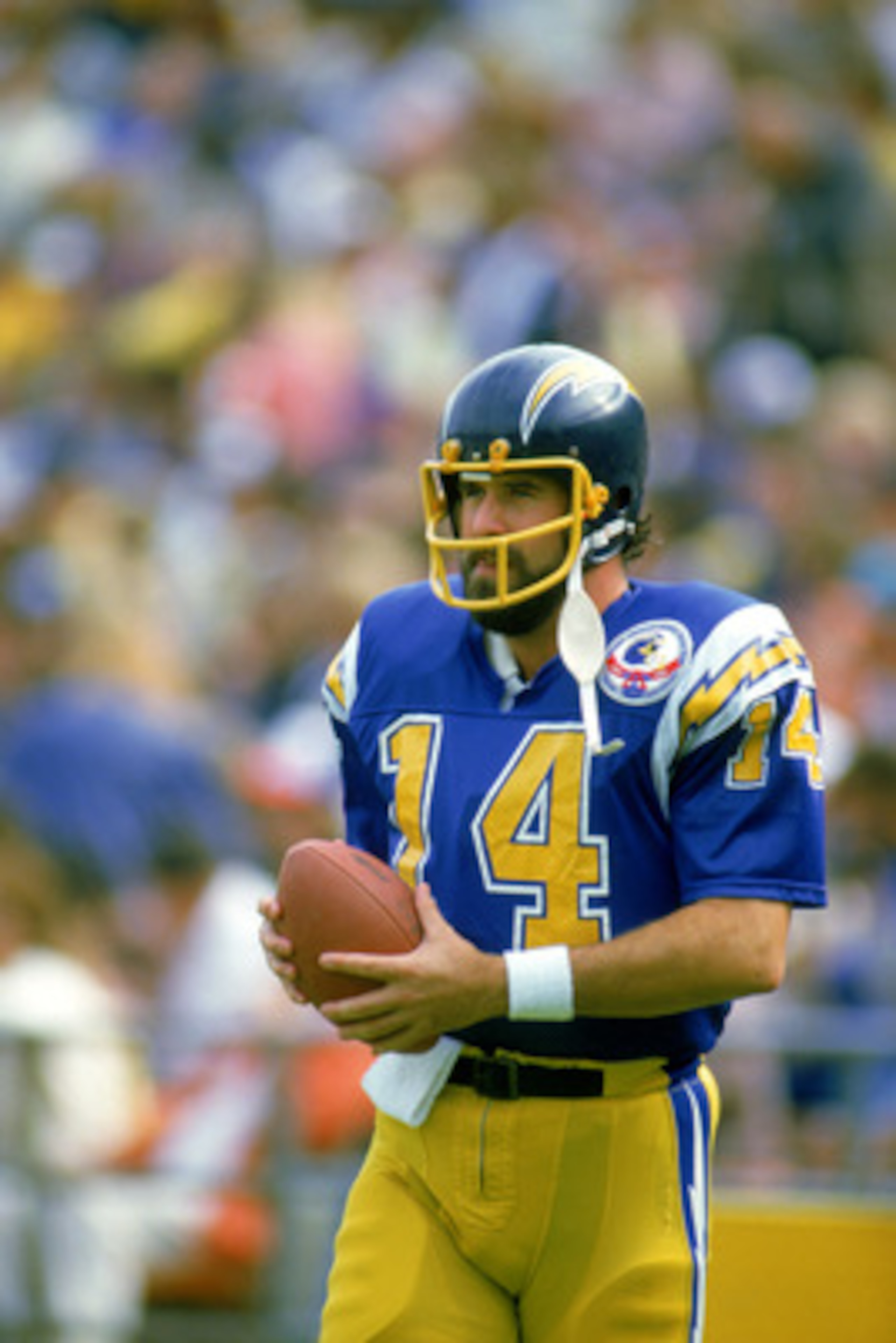 1984:  Dan Fouts #14 of the San Diego Chargers walks with the ball during a 1984 NFL season game. ( Photo by: Tony Duffy/Getty Images)