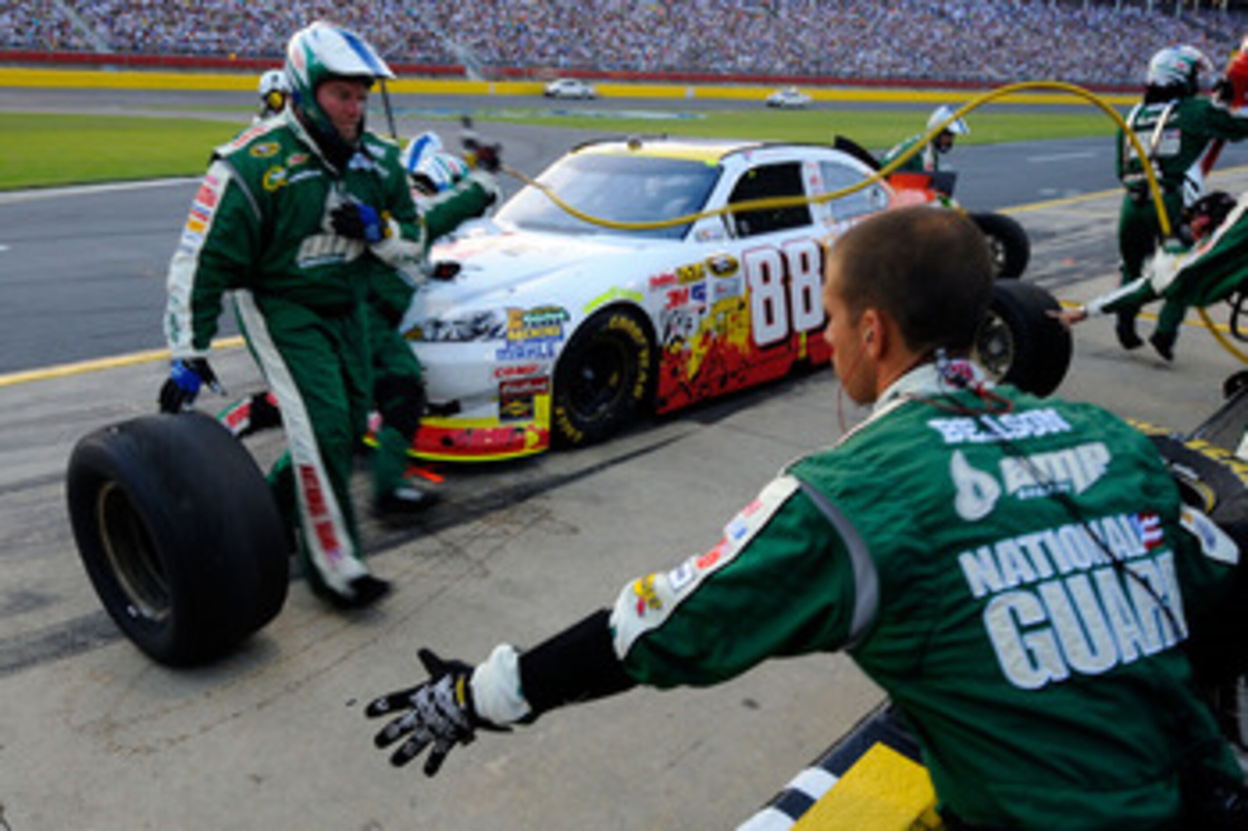 CHARLOTTE, NC - MAY 21:  Dale Earnhardt Jr., driver of the #88 Dale Jr. Foundation/VH1 Save the Music/Amp Energy Sugar-Free/National Guard Chevrolet, makes a pit stop during the NASCAR Sprint Showdown at Charlotte Motor Speedway on May 21, 2011 in Charlot