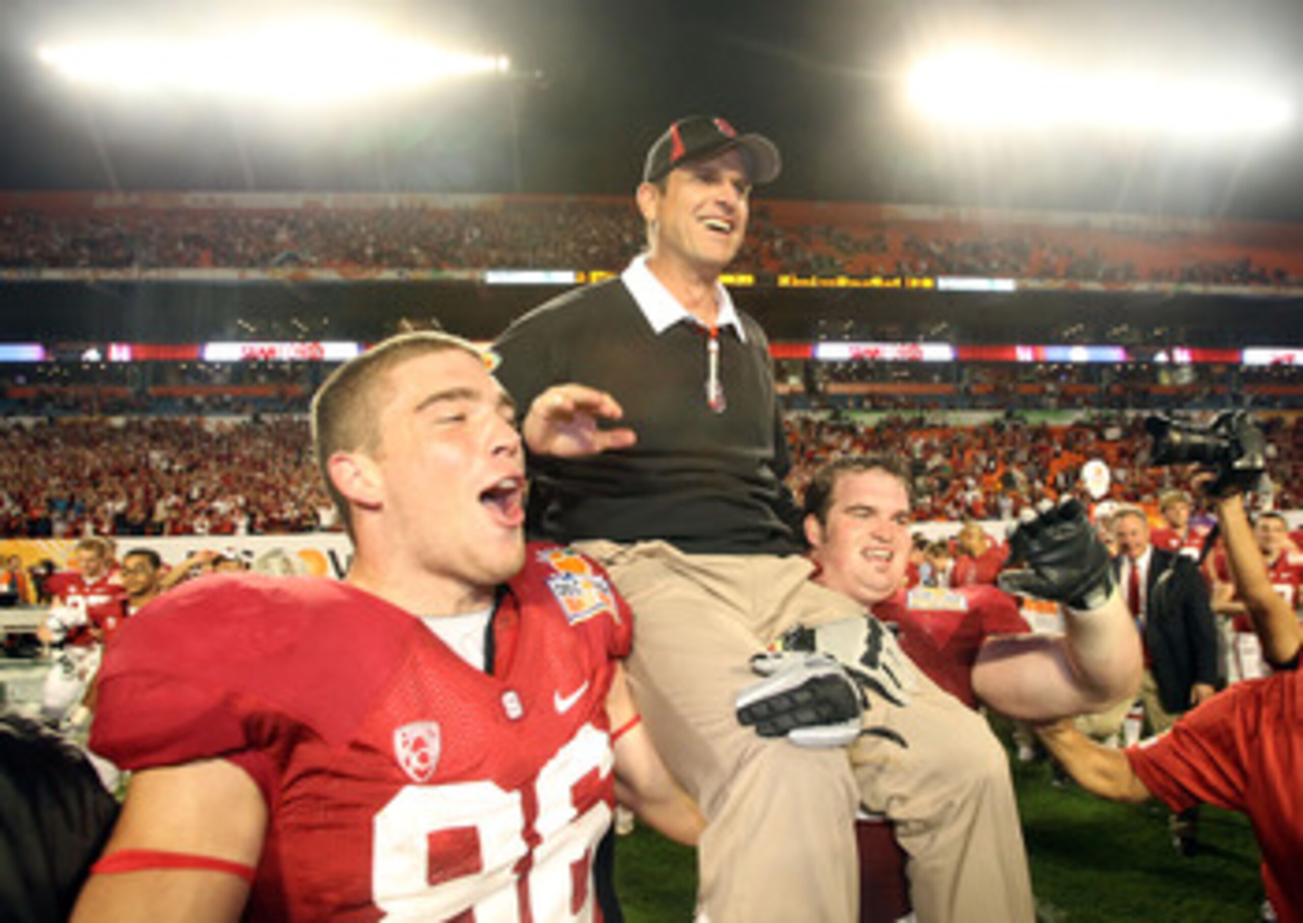 MIAMI, FL - JANUARY 03:  Head coach Jim Harbaugh of the Stanford Cardinal celebrates as he is lifted up by his players including Zach Ertz #86 (L) after Stanford won 40-12 against the Virginai Tech Hokies during the 2011 Discover Orange Bowl at Sun Life S