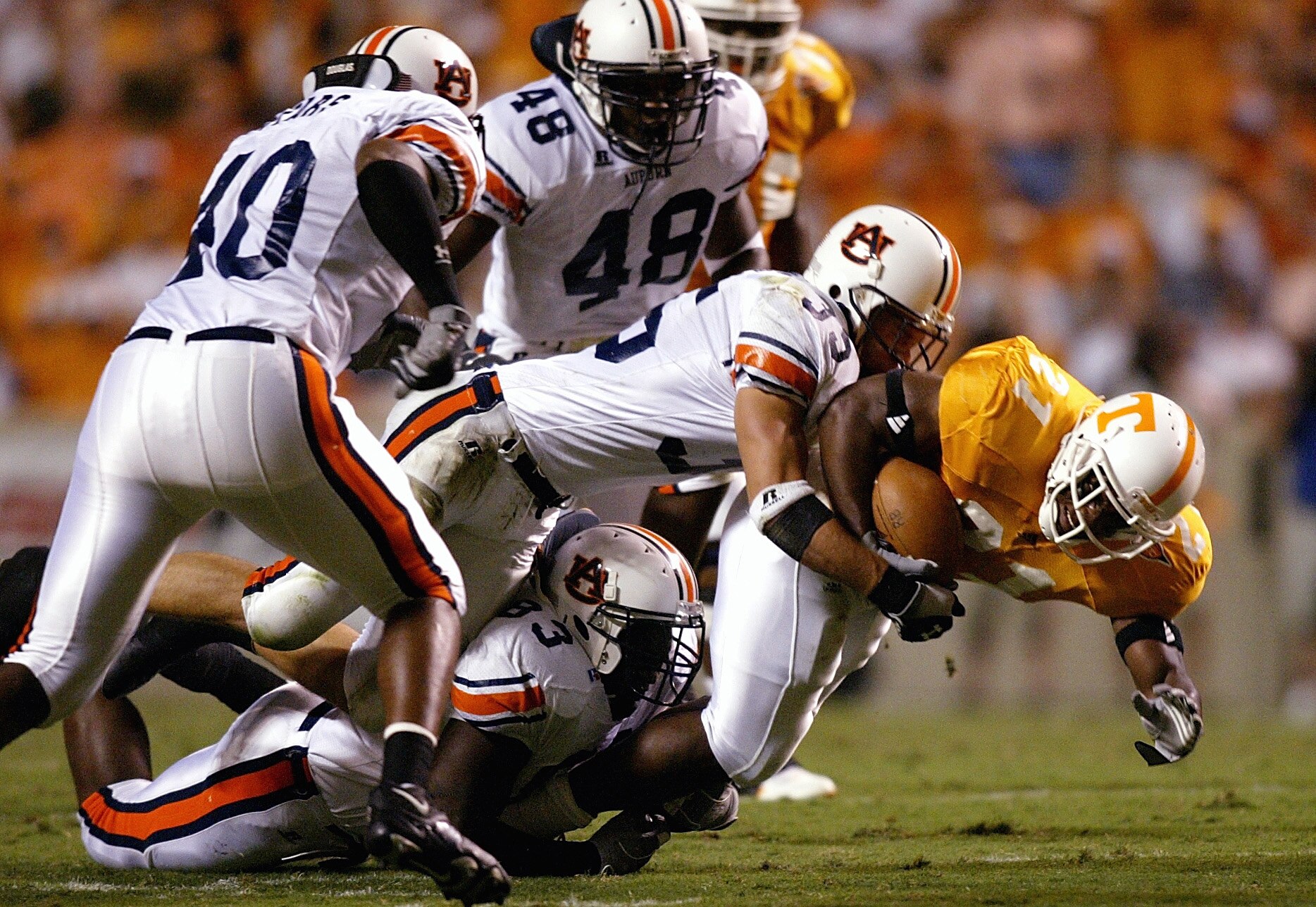 KNOXVILLE, TN - OCTOBER 2:  Cedric Houston #21 of the Tennessee Volunteers is swarmed by the Auburn Tigers defense at Neyland Stadium on October 2, 2004 in Knoxville, Tennessee. (Photo by Streeter Lecka/Getty Images)