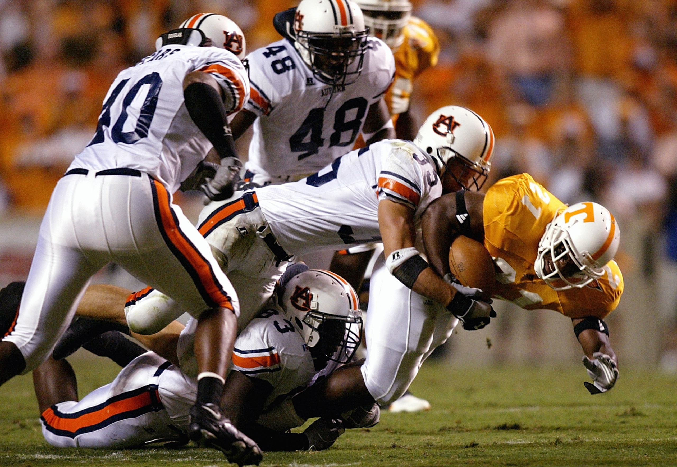 KNOXVILLE, TN - OCTOBER 2:  Cedric Houston #21 of the Tennessee Volunteers is swarmed by the Auburn Tigers defense at Neyland Stadium on October 2, 2004 in Knoxville, Tennessee. (Photo by Streeter Lecka/Getty Images)