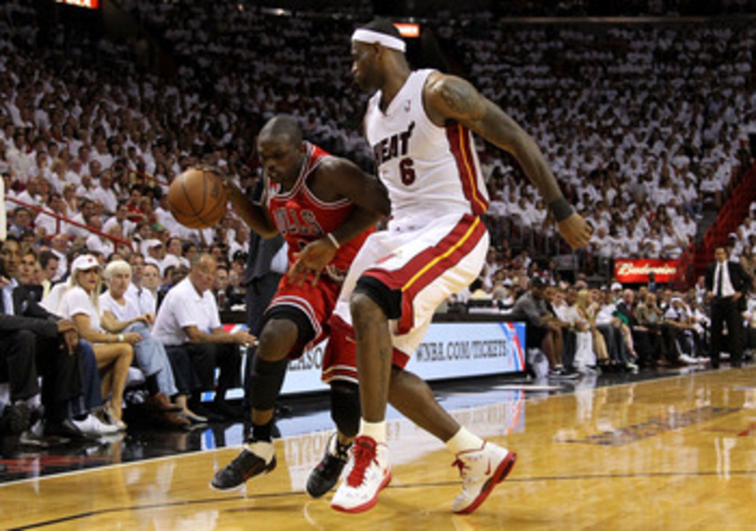 MIAMI, FL - MAY 22:  Luol Deng #9 of the Chicago Bulls drives against LeBron James #6 of the Miami Heat in Game Three of the Eastern Conference Finals during the 2011 NBA Playoffs on May 22, 2011 at American Airlines Arena in Miami, Florida.  NOTE TO USER