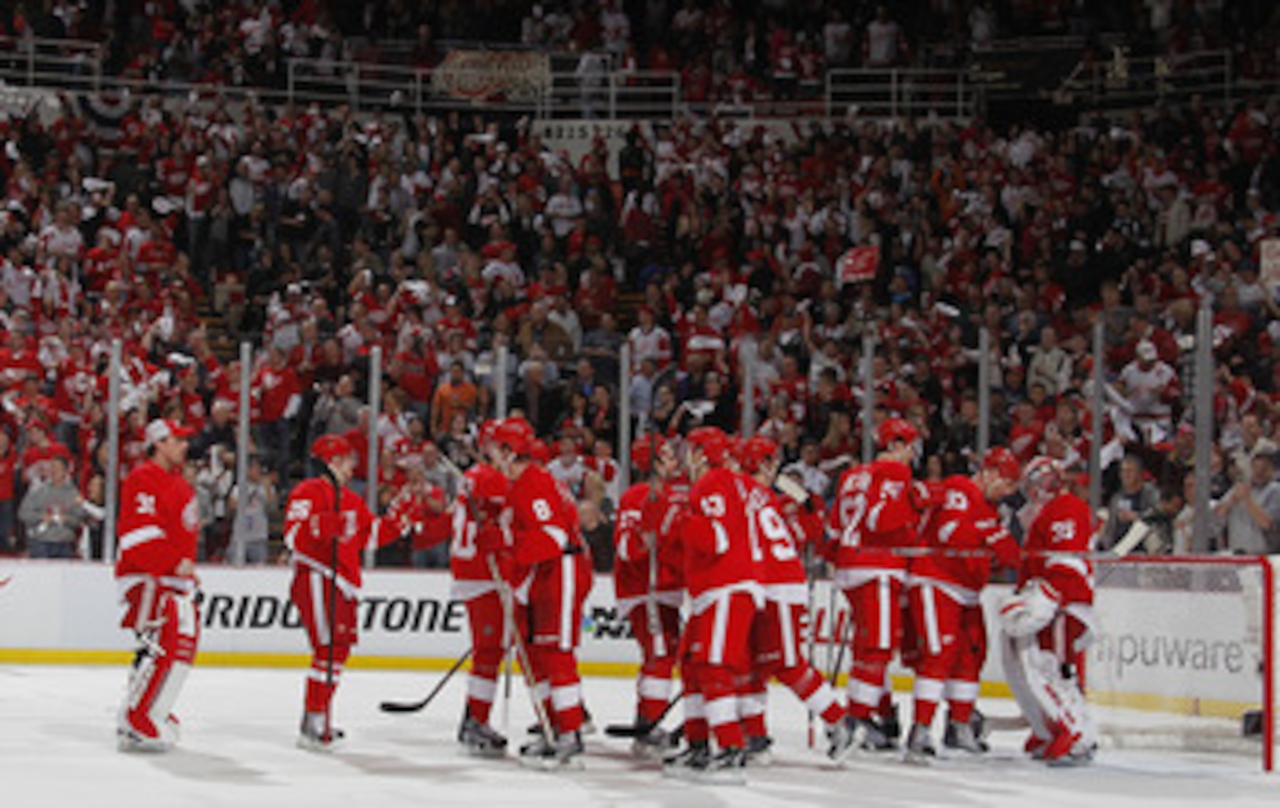 DETROIT, MI - APRIL 16:  Jimmy Howard #35 of the Detroit Red Wings celebrates a 4-3 victory over the Phoenix Coyotes with teammates after Game Two of the Western Conference Quarterfinals during the 2011 Stanley Cup Playoffs at Joe Louis Arena on April 16,