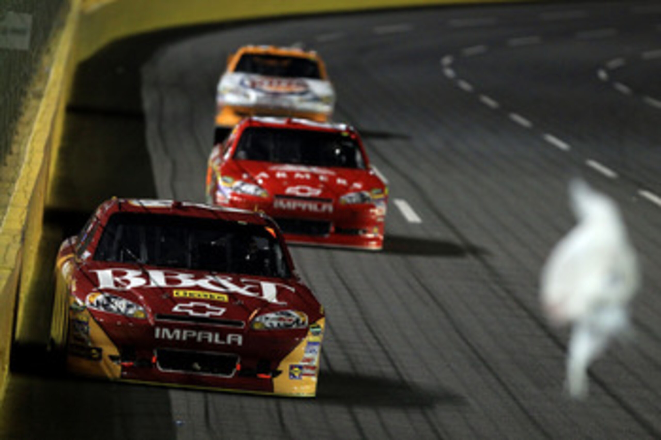 CHARLOTTE, NC - MAY 21:  Debris fly in the air in front of Clint Bowyer, driver of the #33 BB&T Chevrolet, during the NASCAR Sprint All-Star Race at Charlotte Motor Speedway on May 21, 2011 in Charlotte, North Carolina.  (Photo by Streeter Lecka/Getty Ima
