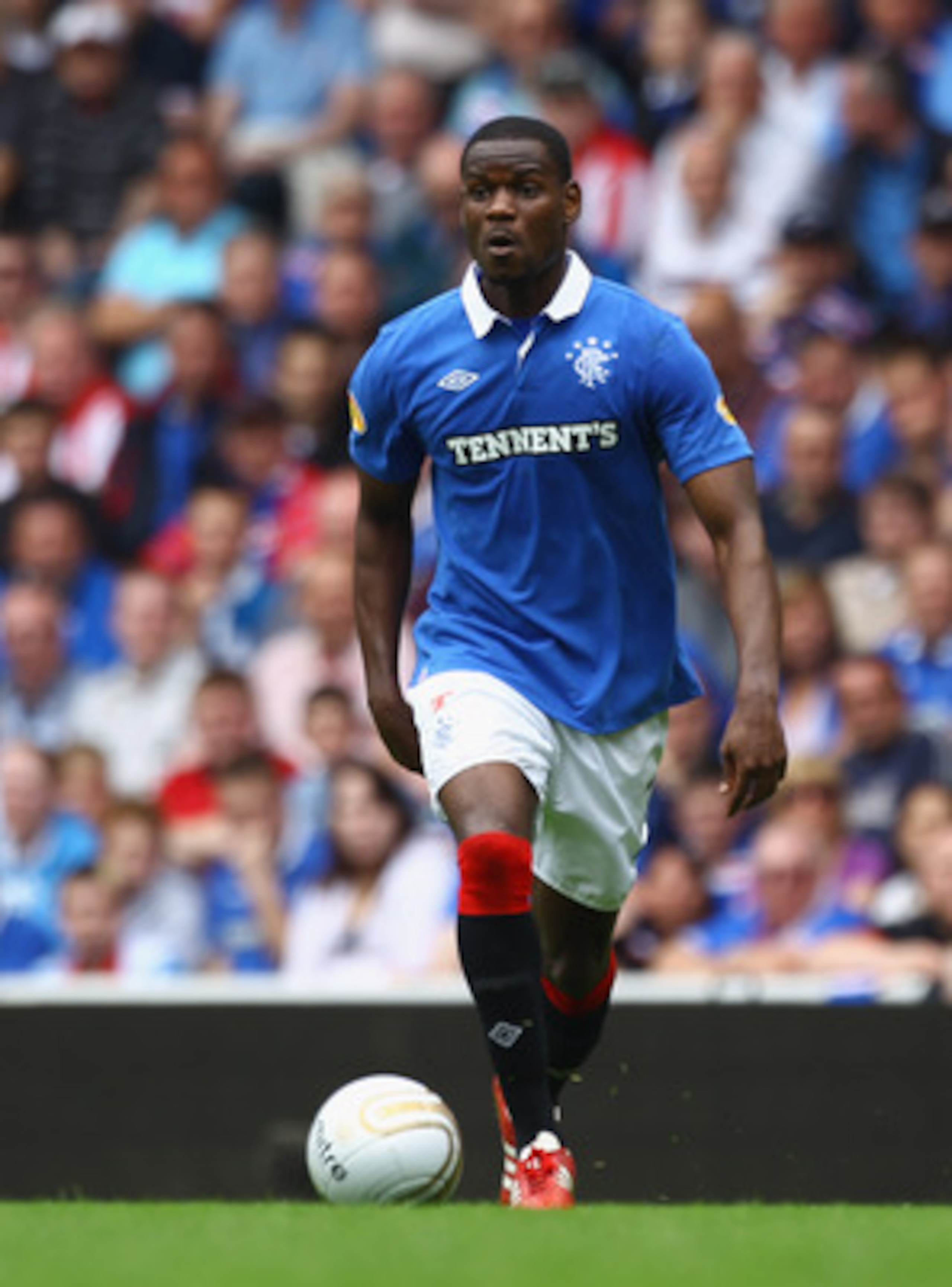 GLASGOW, SCOTLAND - MAY 07:  Maurice Edu of Rangers in action during the Clydesdale Bank Premier League match between Rangers and Hearts at Ibrox Stadium salutes his supporters on May 7, 2011 in Glasgow, Scotland.  (Photo by Jeff J Mitchell/Getty Images)