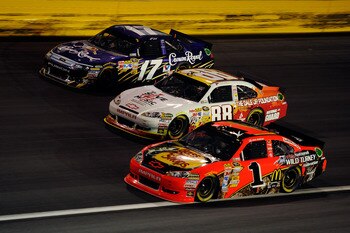 CHARLOTTE, NC - MAY 21:  Jamie McMurray, driver of the #1 Bass Pro Shops/NWTF Chevrolet, races Dale Earnhardt Jr., driver of the #88 Dale Jr. Foundation/VH1 Save the Music/Amp Energy Sugar-Free/National Guard Chevrolet, and Matt Kenseth, driver of the #17