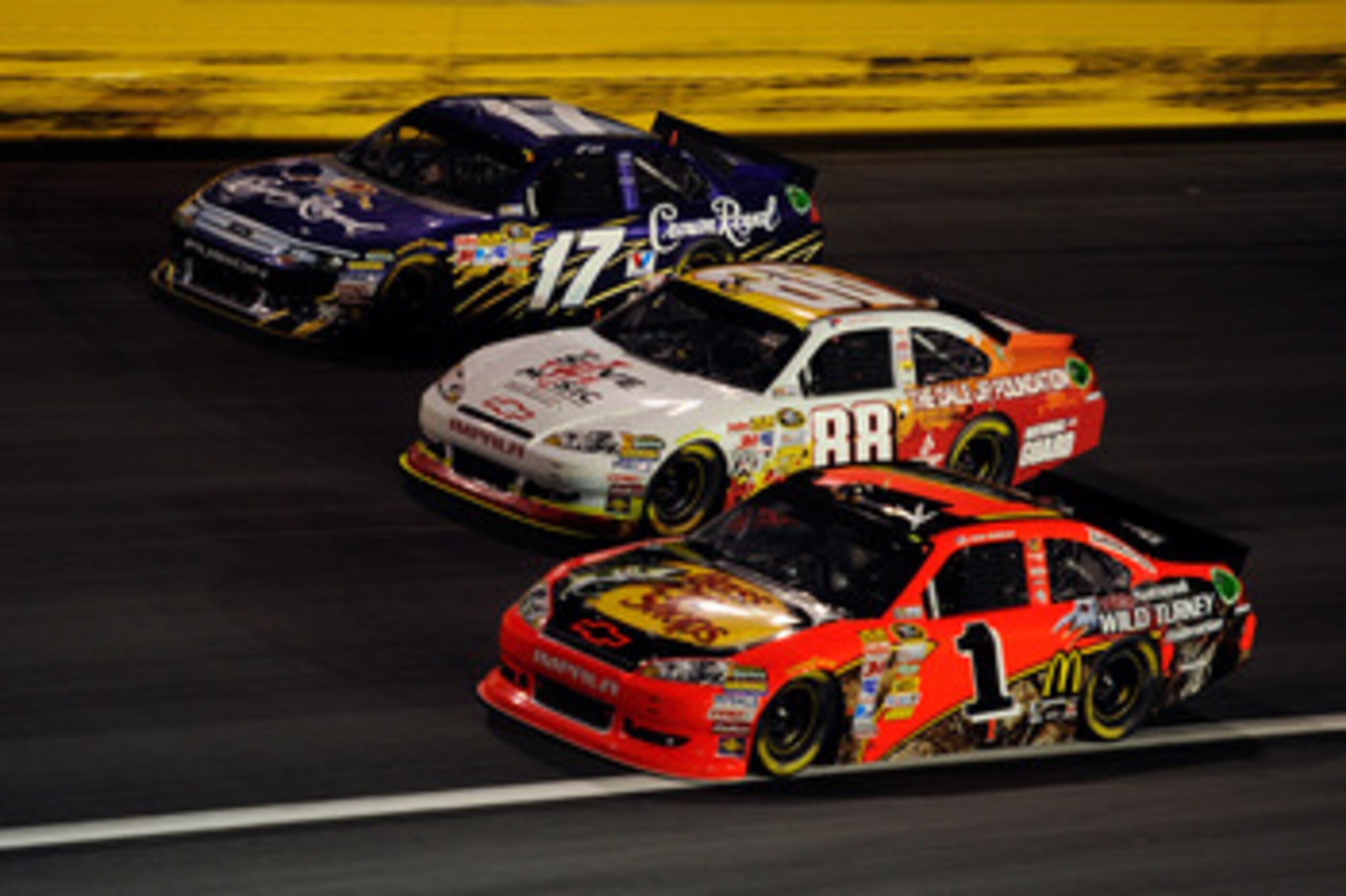 CHARLOTTE, NC - MAY 21:  Jamie McMurray, driver of the #1 Bass Pro Shops/NWTF Chevrolet, races Dale Earnhardt Jr., driver of the #88 Dale Jr. Foundation/VH1 Save the Music/Amp Energy Sugar-Free/National Guard Chevrolet, and Matt Kenseth, driver of the #17
