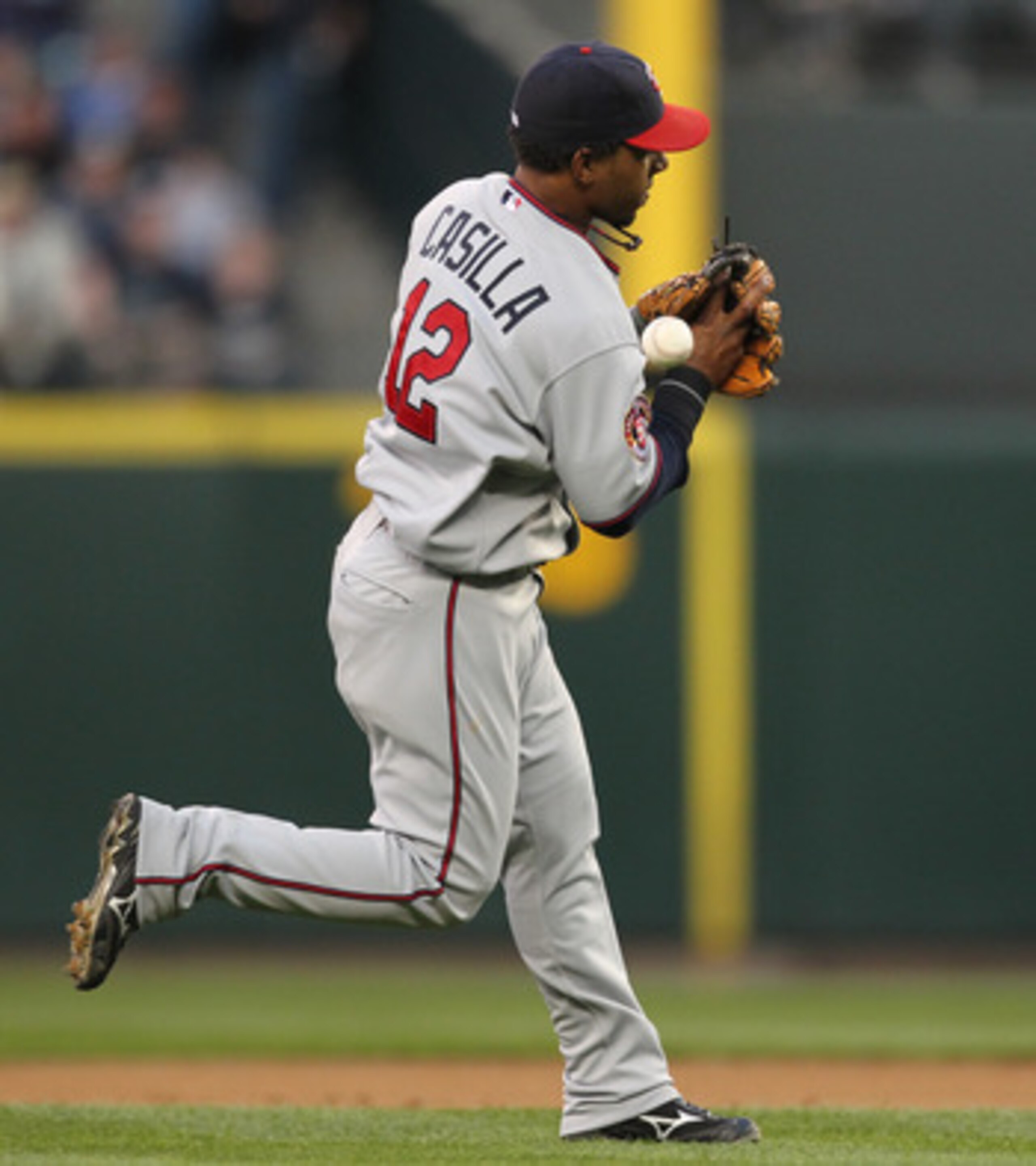 SEATTLE - AUGUST 27:  Shortstop Alexi Casilla #12 of the Minnesota Twins bobbles an infield single by Adam Moore of the Seattle Mariners at Safeco Field on August 27, 2010 in Seattle, Washington. The Twins won 6-3. (Photo by Otto Greule Jr/Getty Images)
