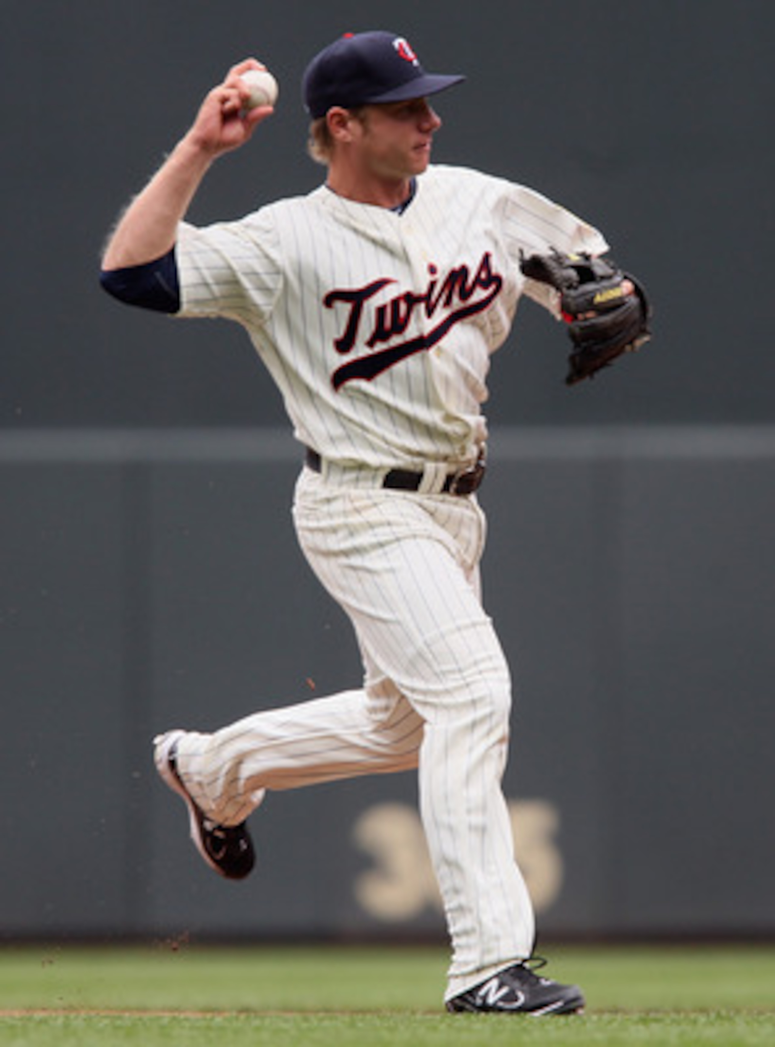 MINNEAPOLIS, MN - APRIL 08:  Luke Hughes #38 of the Minnesota Twins sends the ball to first base against the Oakland Athletics during Opening Day on April 8, 2011 at Target Field in Minneapolis, Minnesota.  (Photo by Elsa/Getty Images)