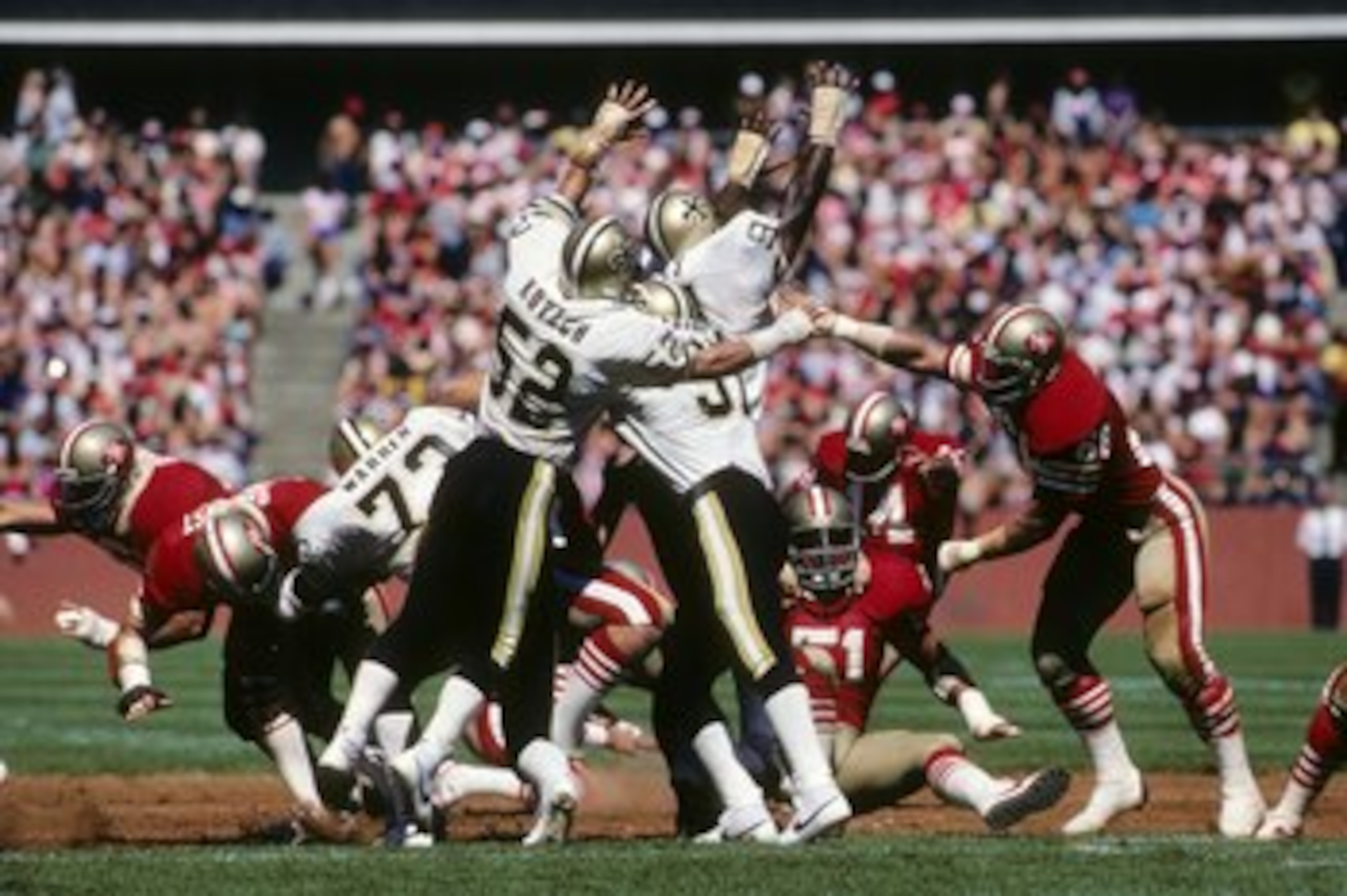 SAN FRANCISCO - SEPTEMBER 16:  Linebacker Jim Kovach #52 and defensive end Jim Wilks #94 of the New Orleans Saints attempt to block a kick by Ray Wersching #14 of the San Francisco 49ers during a game at Candlestick Park on September 16, 1984 in San Franc
