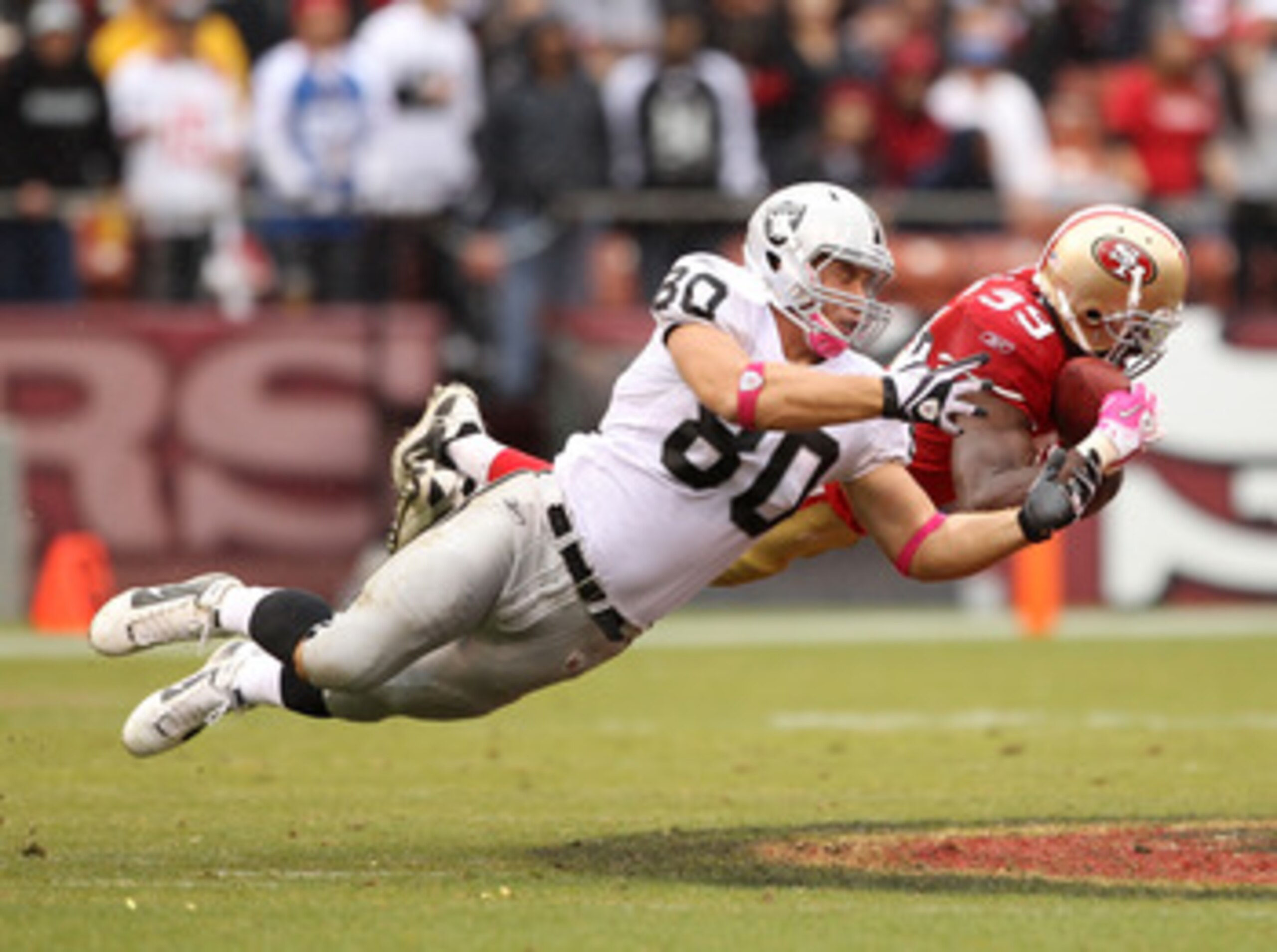 SAN FRANCISCO - OCTOBER 17:  Manny Lawson #99 of the San Francisco 49ers intercepts a pass intended for Zach Miller #80 of the Oakland Raiders at Candlestick Park on October 17, 2010 in San Francisco, California.  (Photo by Ezra Shaw/Getty Images)