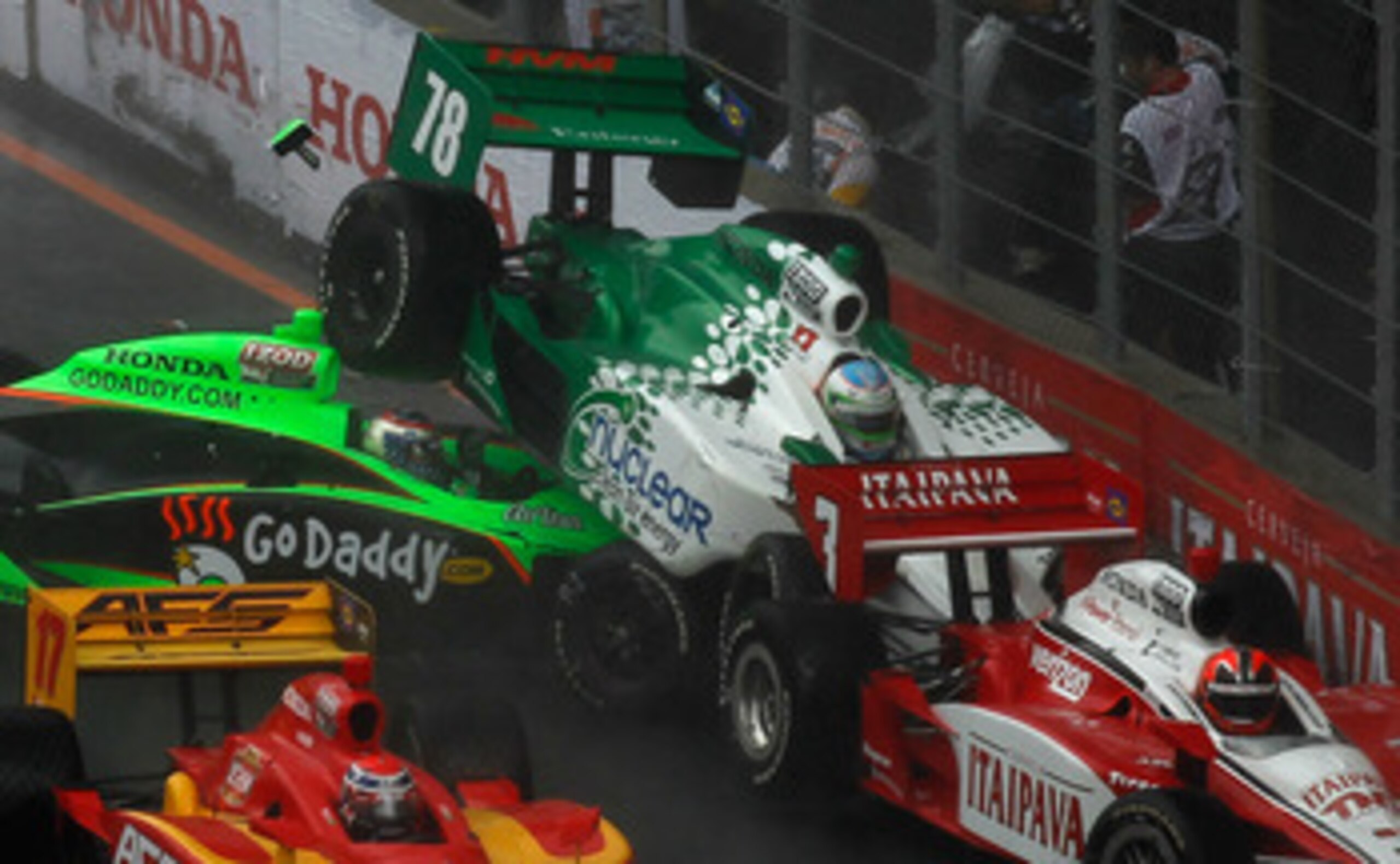SAO POULO, BRAZIL - MAY 01:  Danica Patrick crashes her #7 GoDaddy.com Andretti Autosport Honda Dallara in to Simona de Silvestro in her #78 Nuclear Clean Air Energy HVM Racing Honda Dallara and Helio Castroneves in his #3 Itaipava Team Penske Dallara Hon