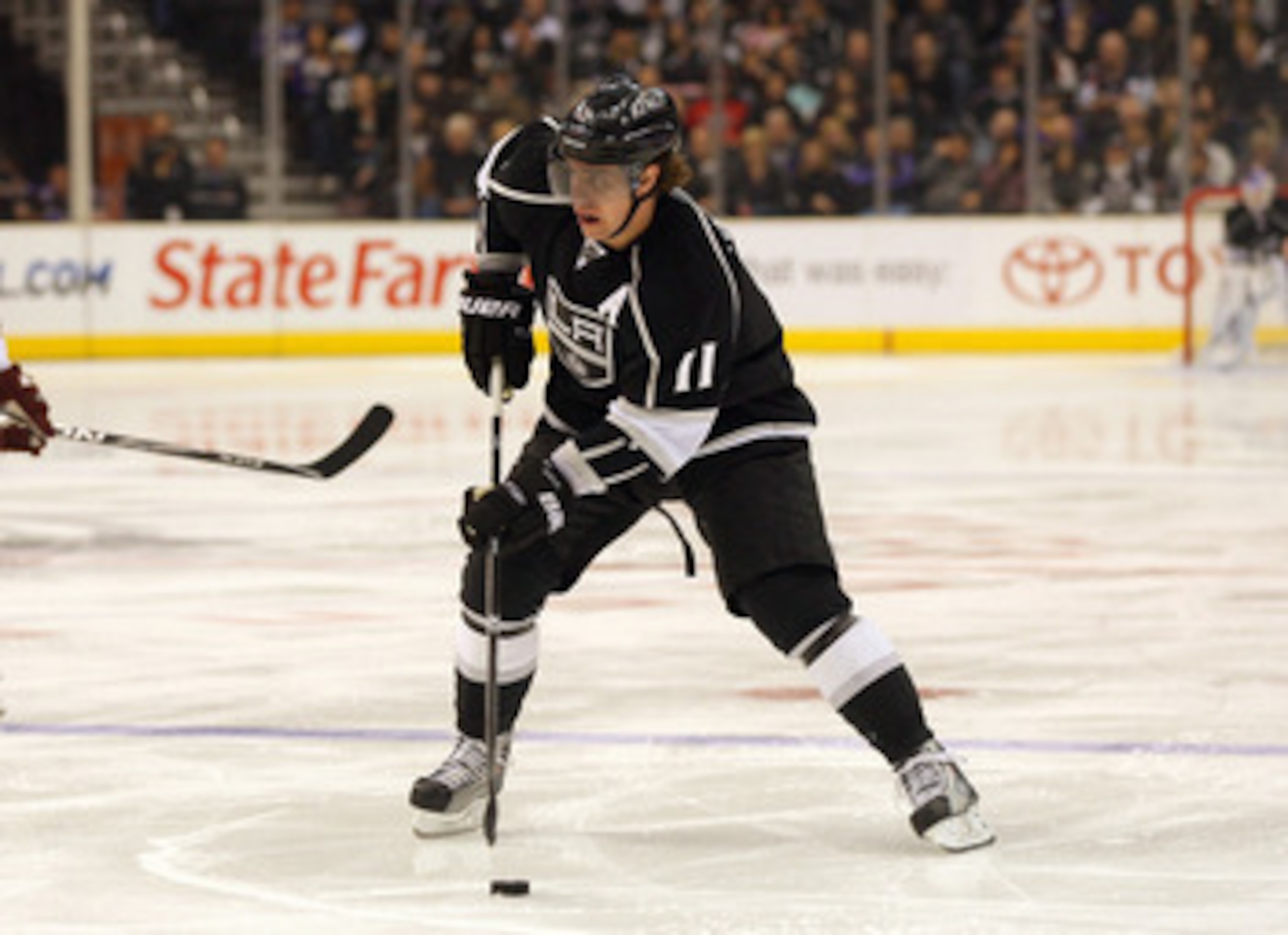 LOS ANGELES, CA - MARCH 03:  Anze Kopitar #11 of the Los Angeles Kings skates the puck into the Phoenix Coyotes zone in the second period during the NHL game at Staples Center on March 3, 2011 in Los Angeles, California. The Kings defeated the Coyotes 1-0