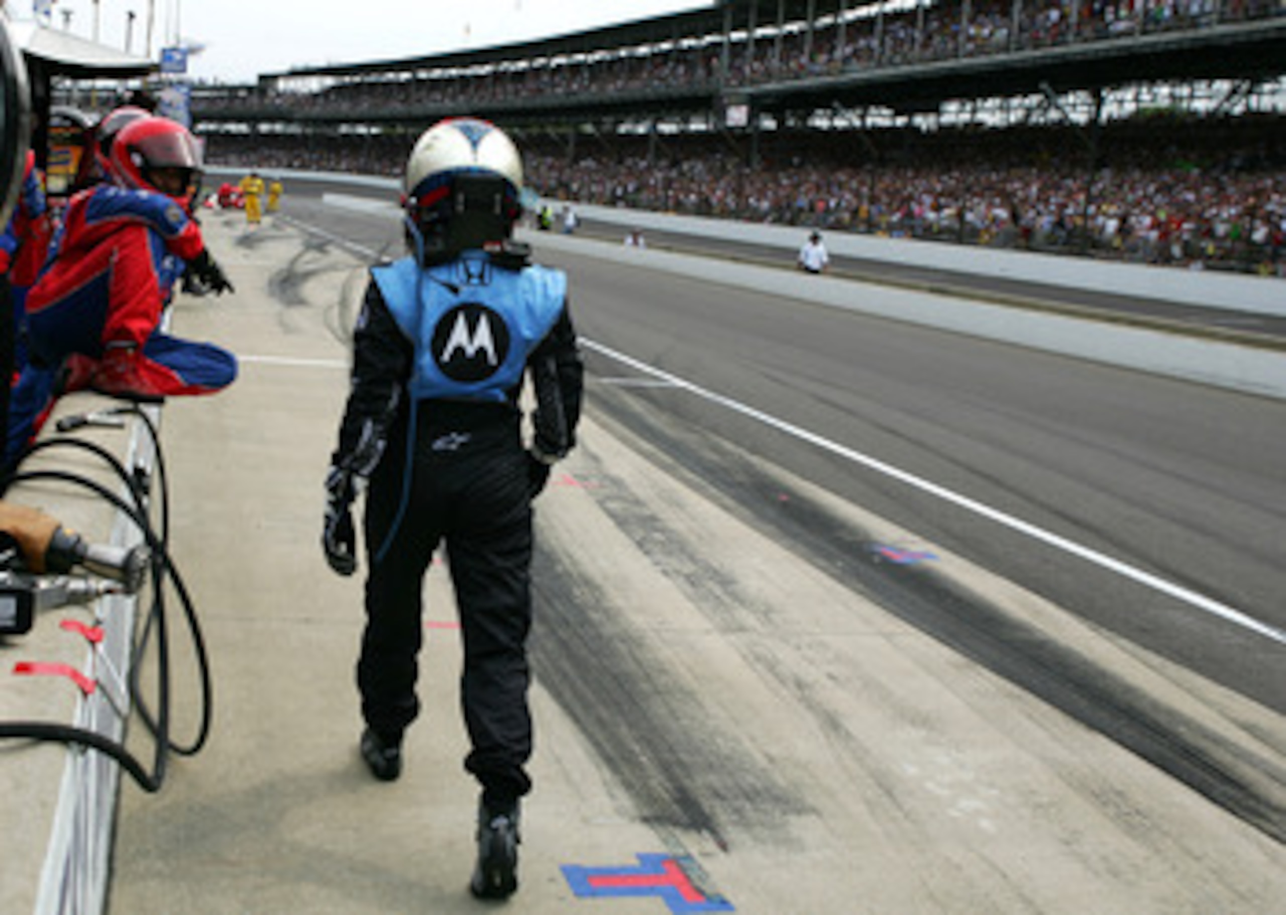 INDIANAPOLIS, IN - MAY 25:  Danica Patrick driver of the #7 Andretti Green Racing Motorola Dallara Honda walks towards pit box of Ryan Briscoe driver of the #6 Team Penske Dallara Honda after crashing with Briscoe during the IRL IndyCar Series 92nd runnin